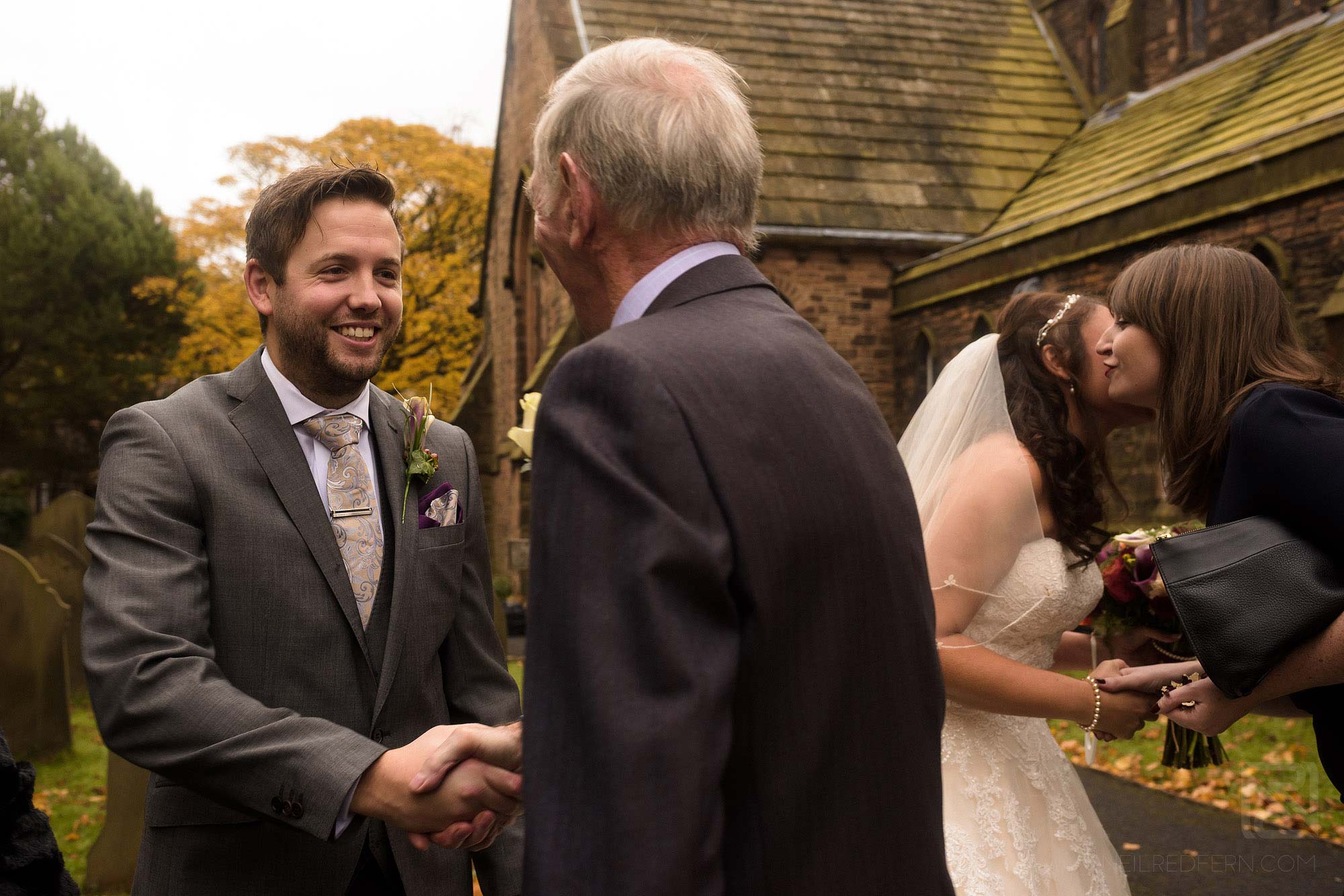 guests congratulating bride and groom