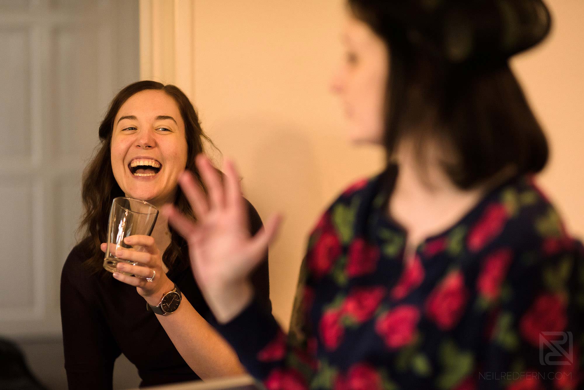 bridesmaid laughing on morning of wedding