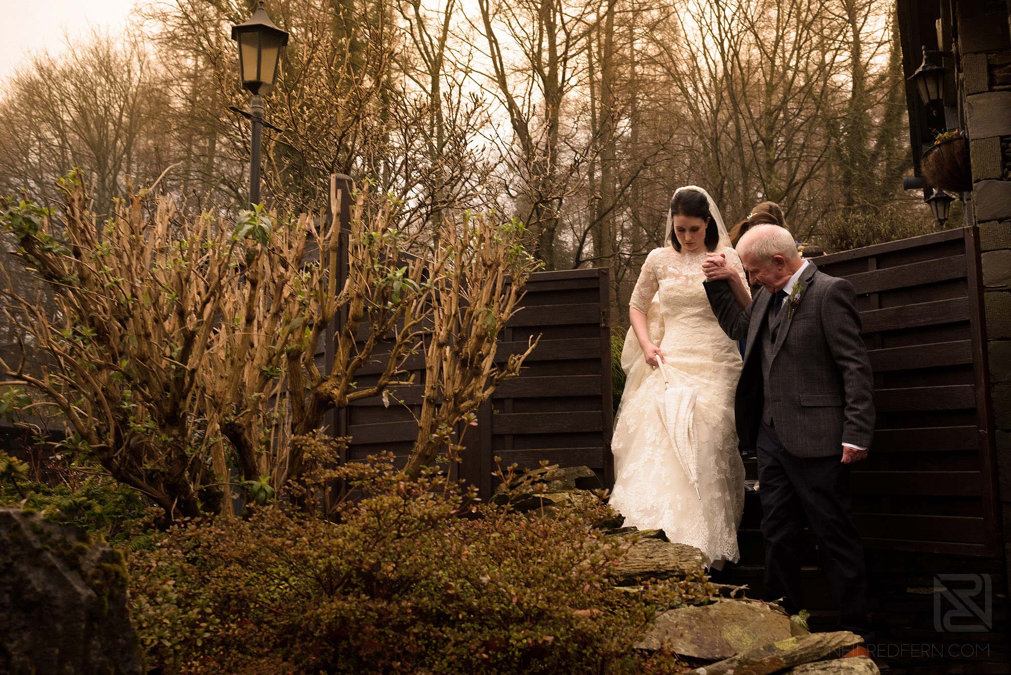 bride and father walking together at Lake District winter wedding
