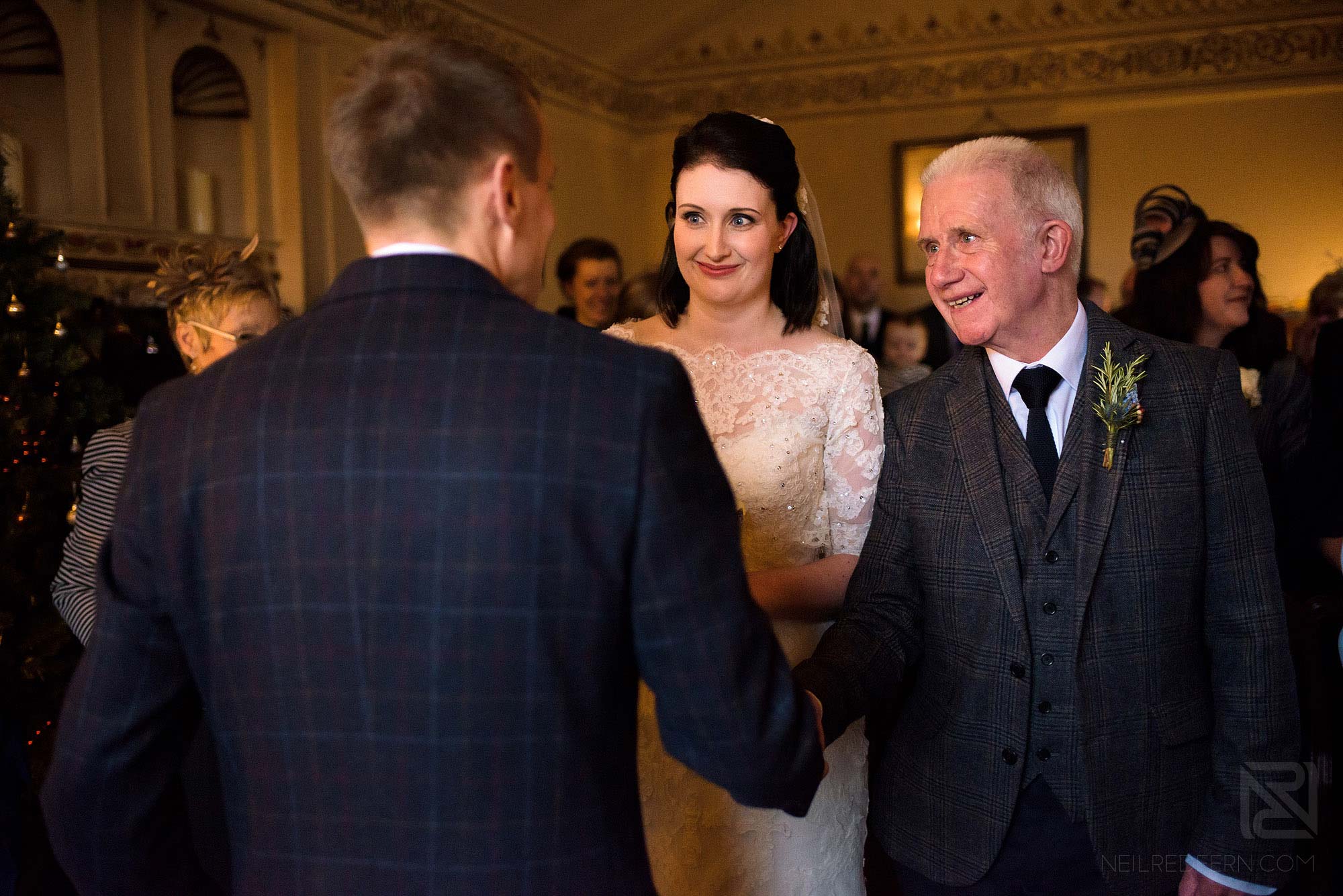 bride and father walking down aisle at Lake District winter wedding
