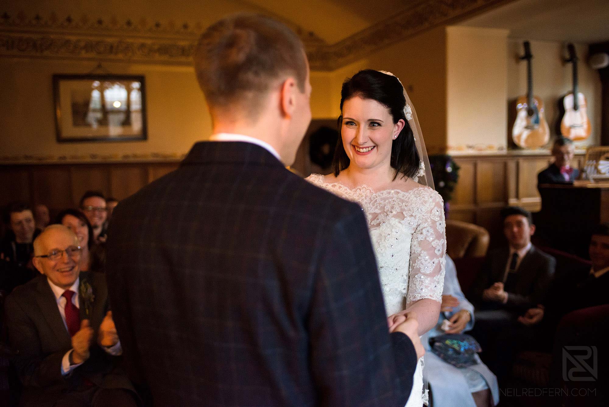 bride smiling at groom during wedding ceremony in the Lake District