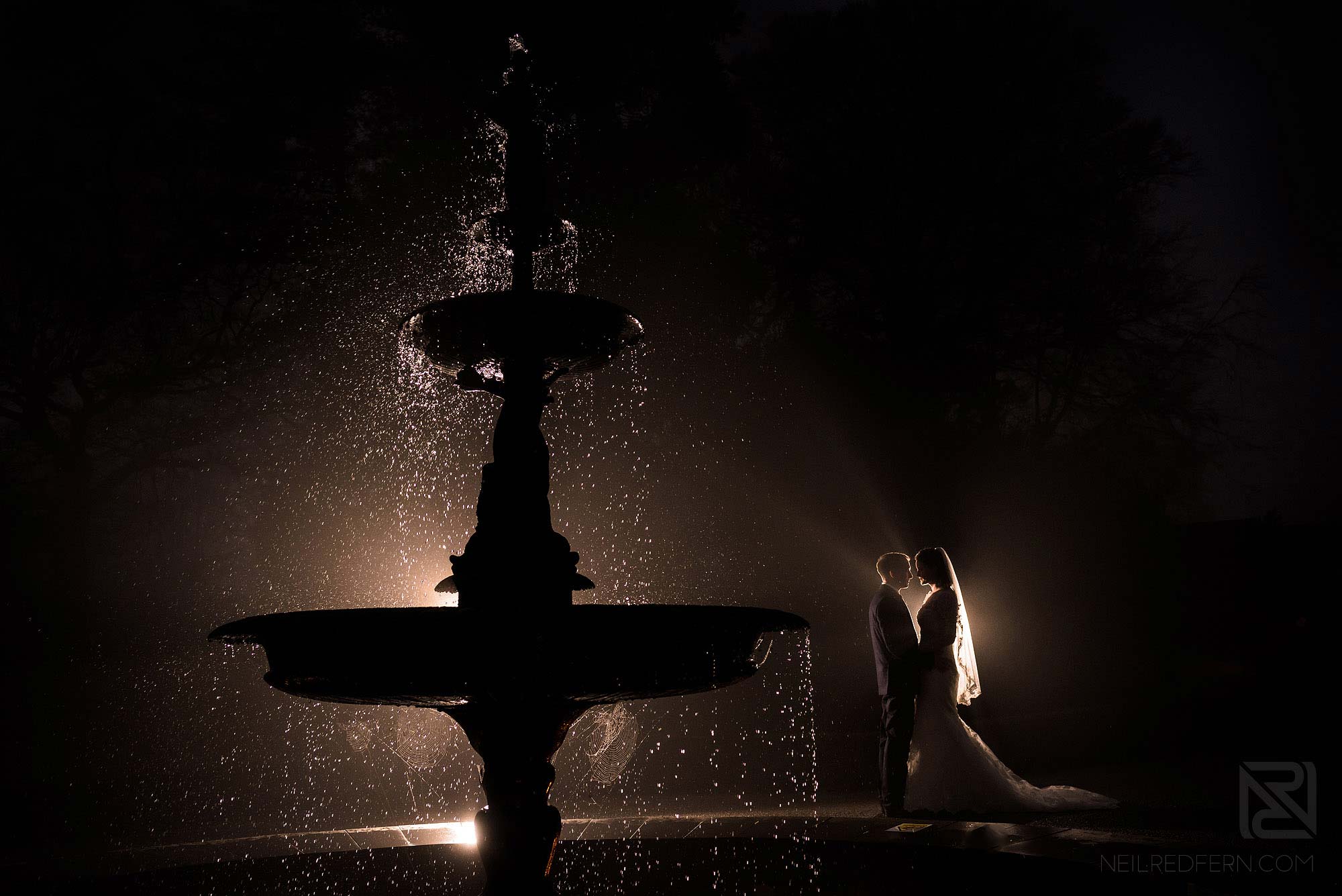 creative night time photograph of bride and groom taken at winter wedding in the Lake District