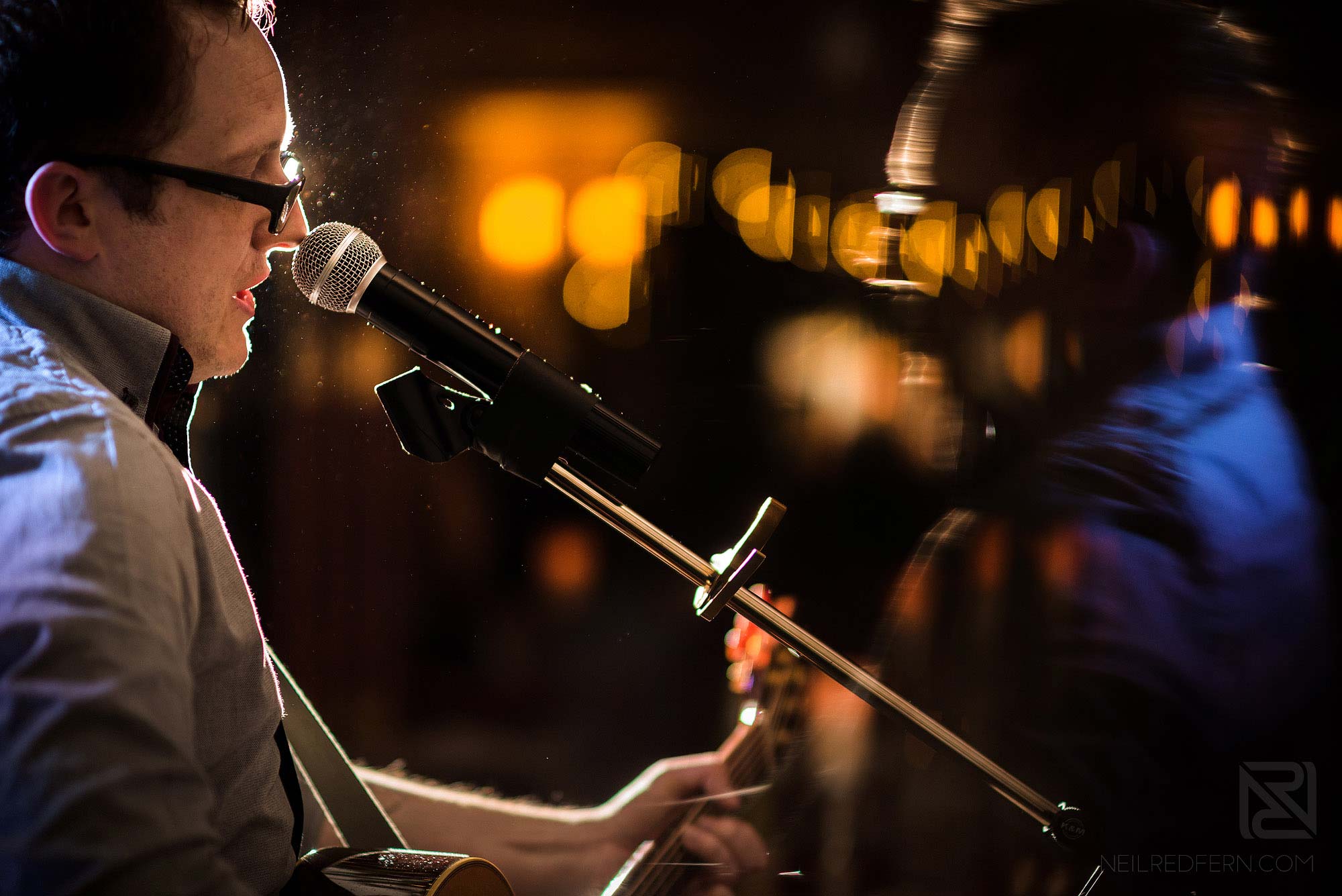 wedding singer playing guitar at wedding reception