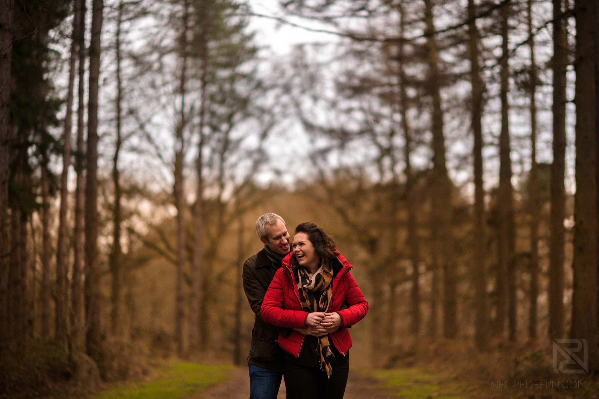 Woodland engagement shoot 3 couple laughing on woodland engagement shoot