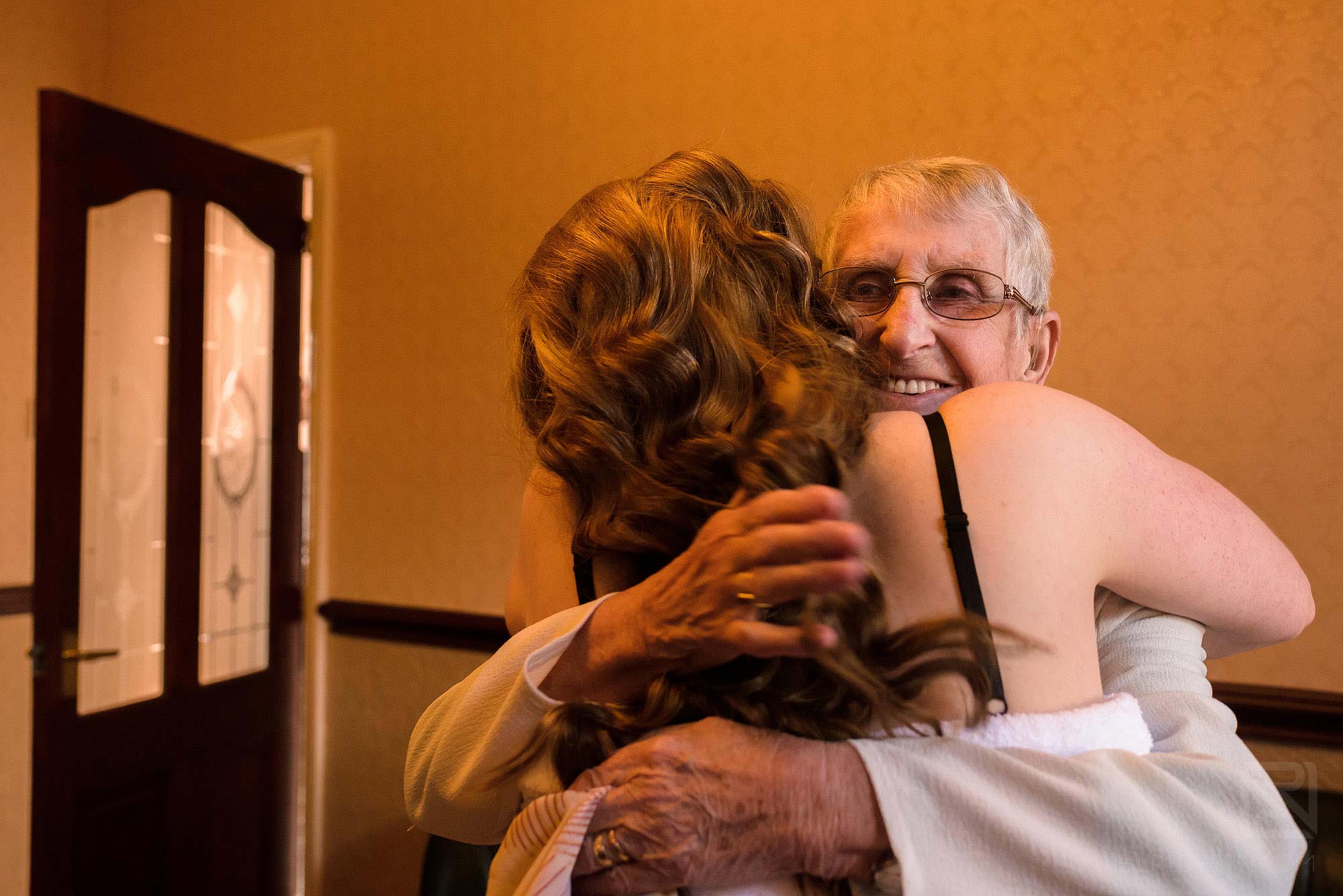 Manchester Museum wedding photography 3 bride hugging grandmother on wedding morning