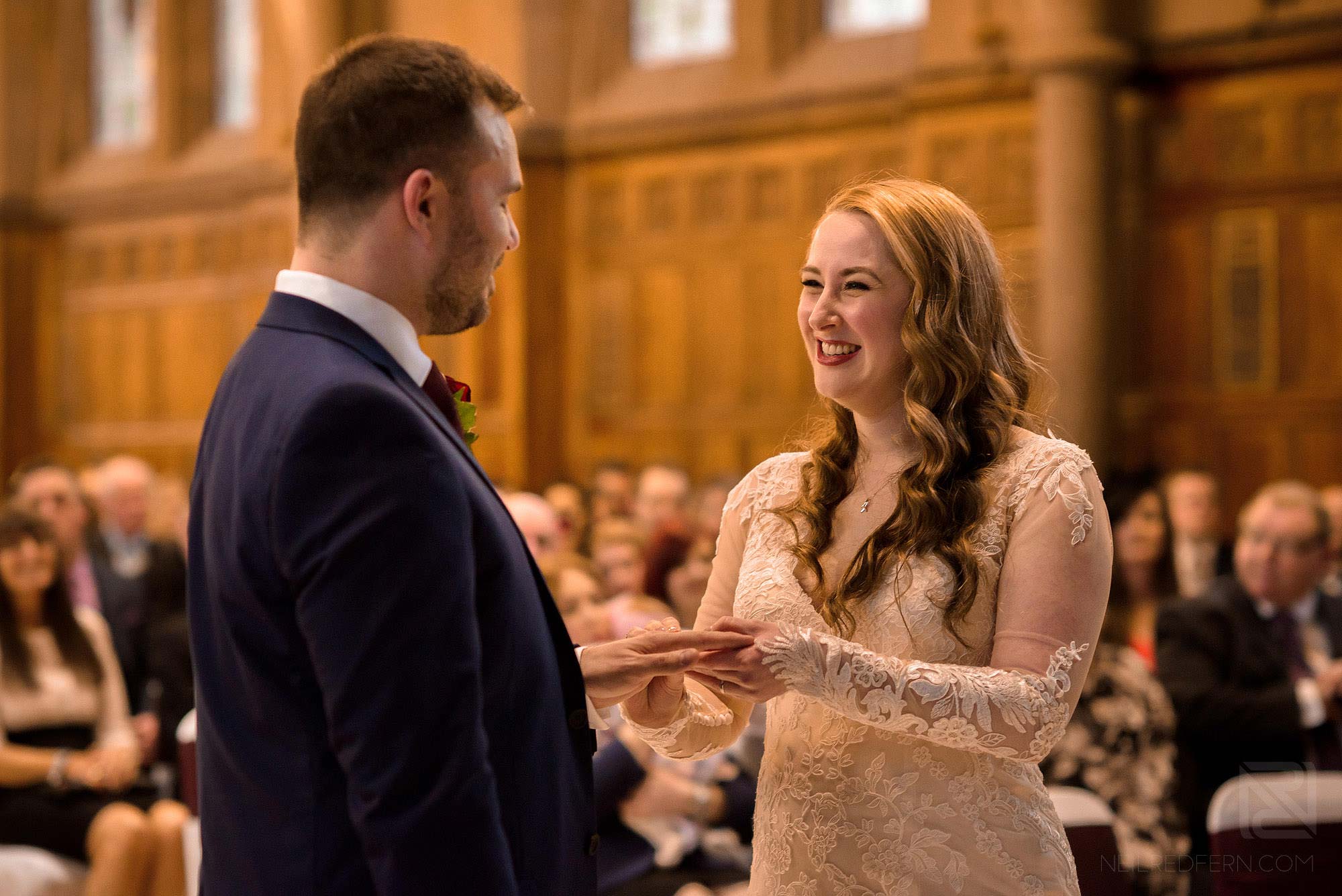Manchester Museum wedding photography 17 bride and groom exchanging rings during wedding ceremony