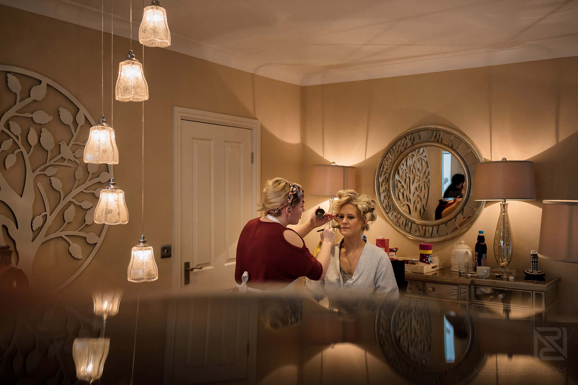 bridesmaid having make up put on at Rowton Hall
