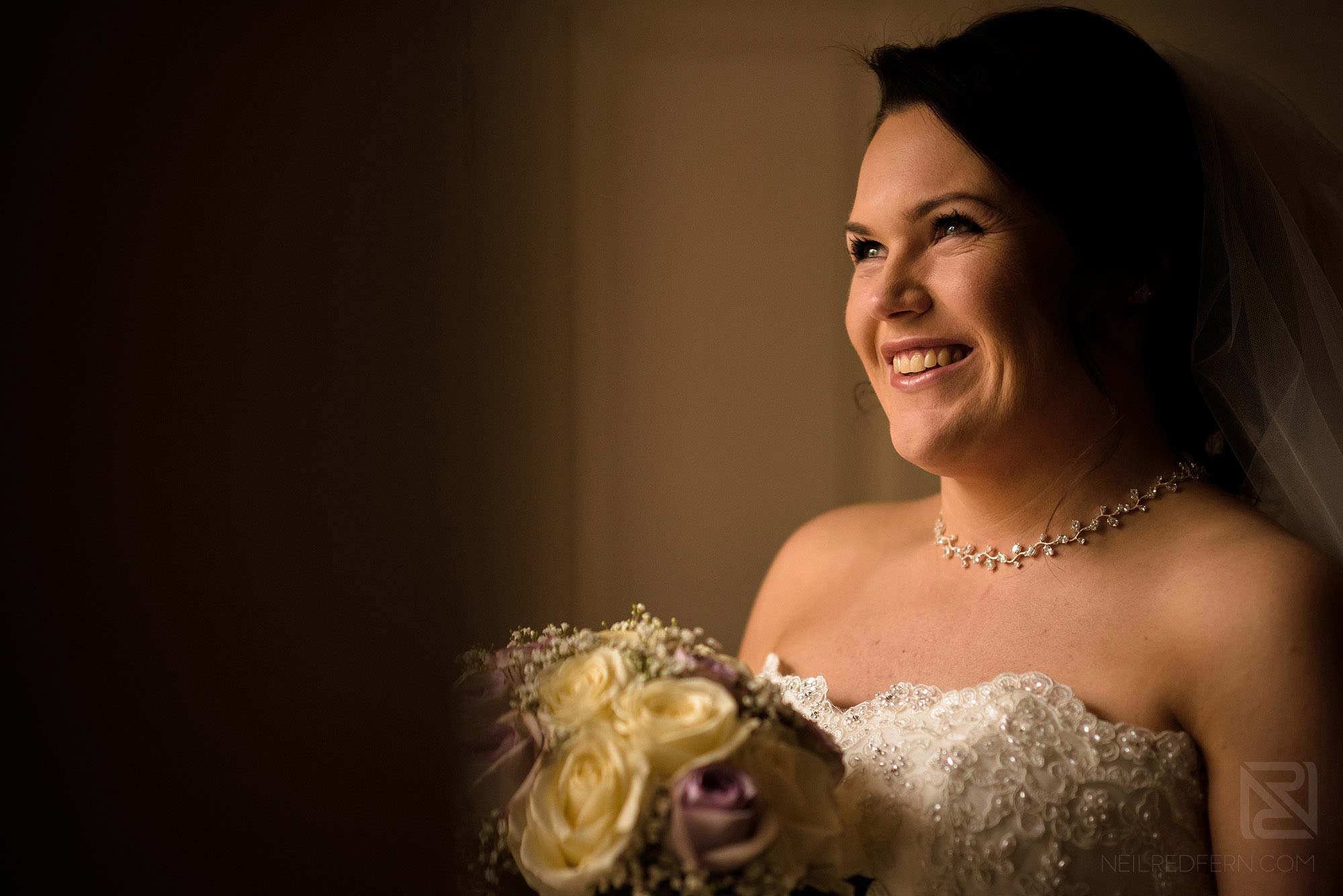beautiful portrait of happy bride holding bouquet