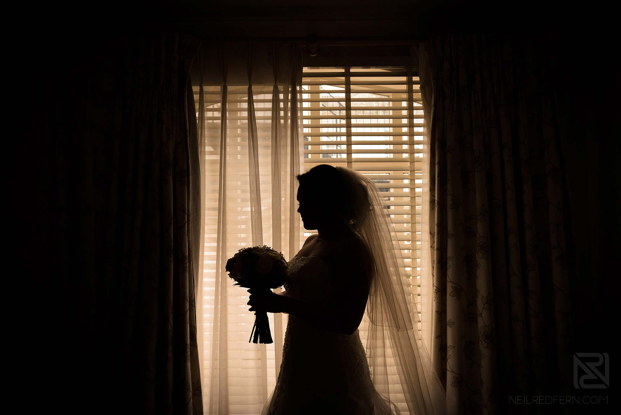 silhouette photograph of bride holding bouquet