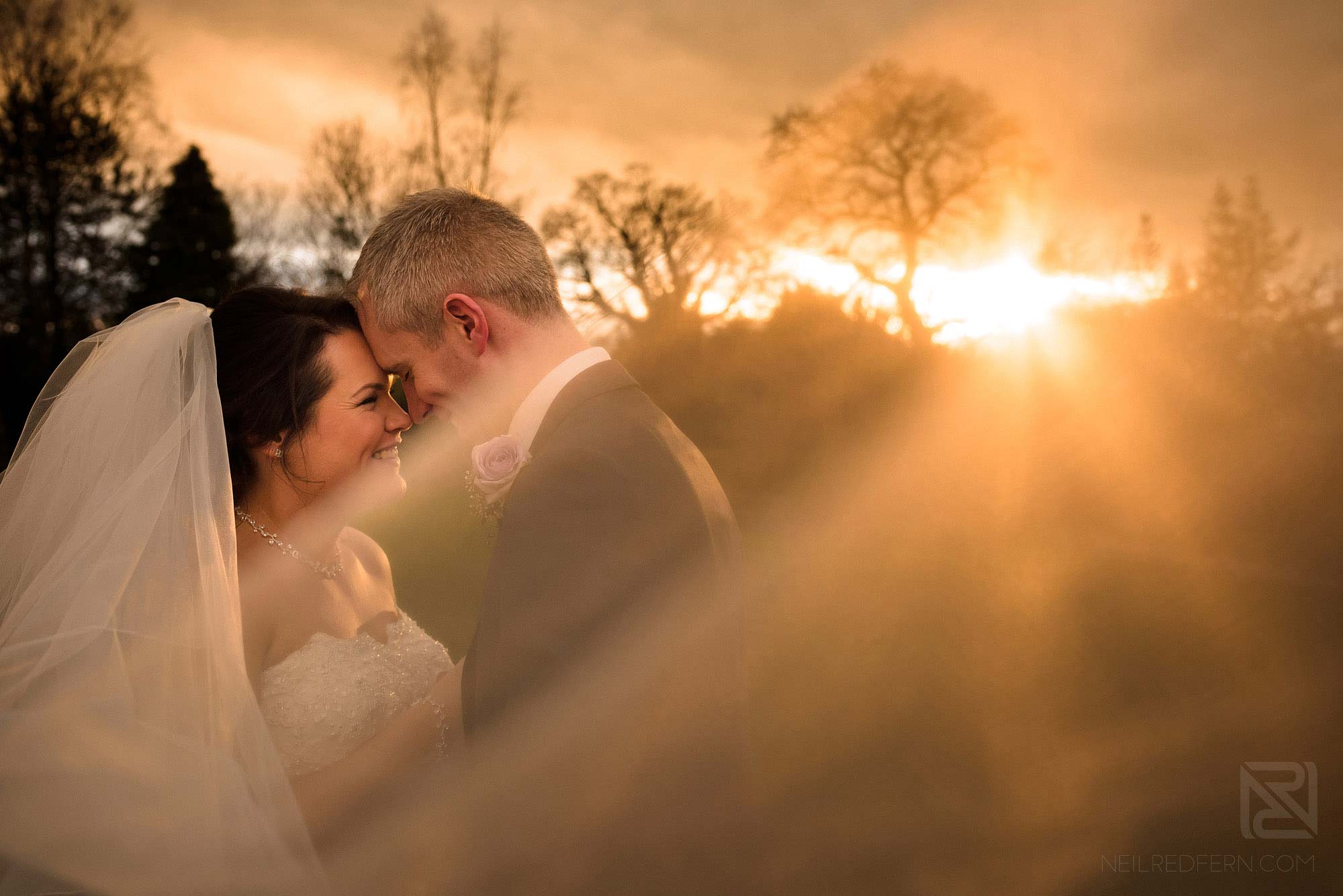 portrait of newlyweds at sunset