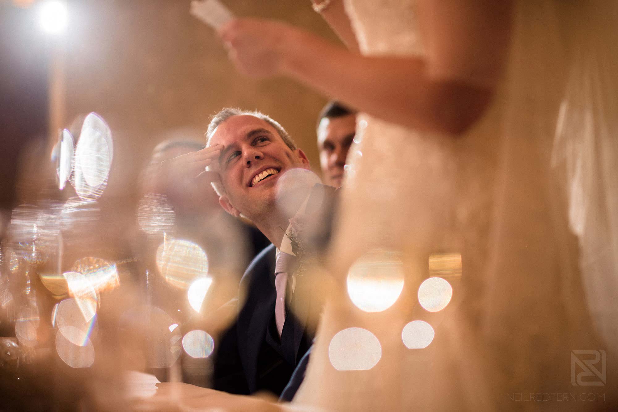 groom looking at wife during wedding speeches at Rowton Hall
