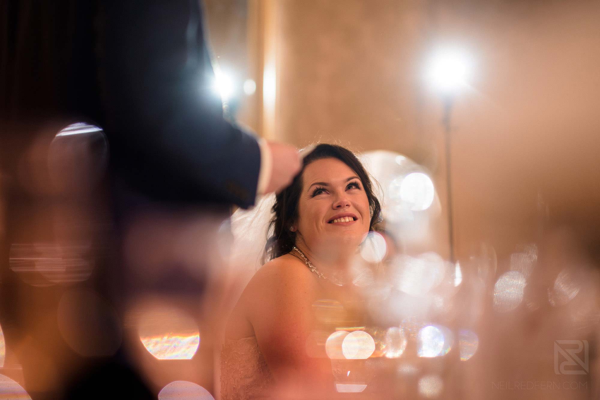 bride smiling and happy during wedding speeches