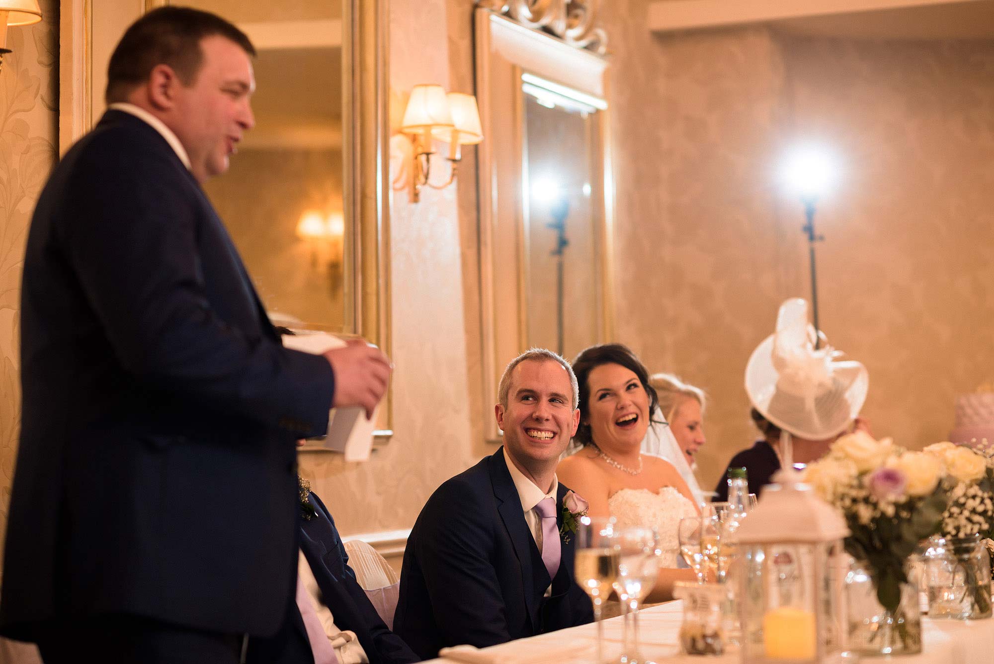 top table laughing and smiling during best man's speech