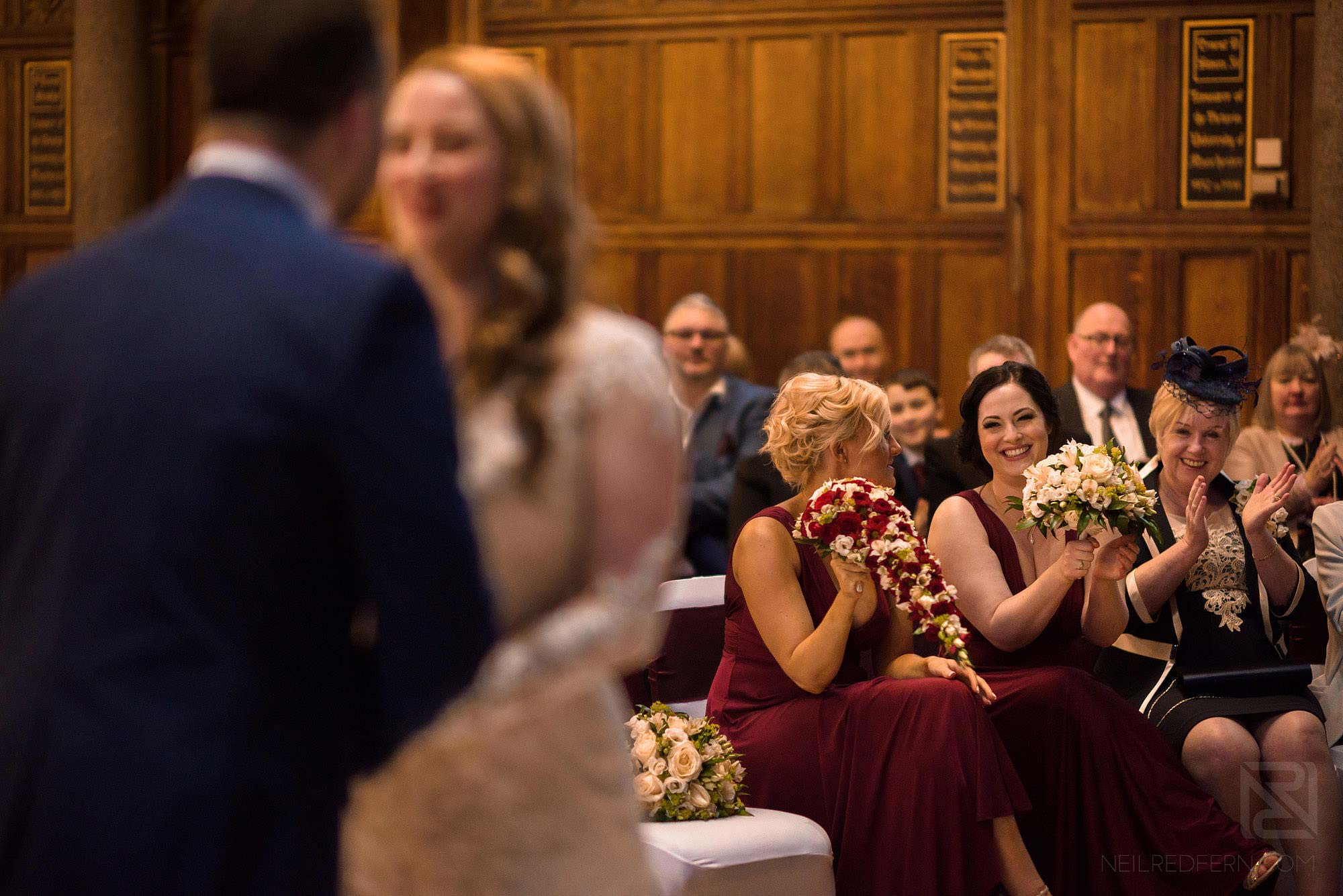 Manchester Museum wedding photography 18 bridesmaids smiling during wedding ceremony