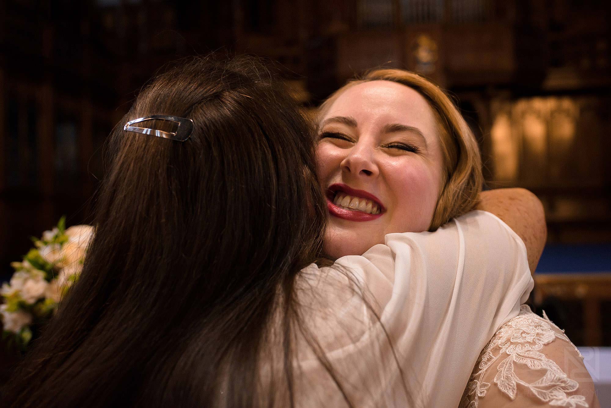 Manchester Museum wedding photography 19 wedding guest hugging bride