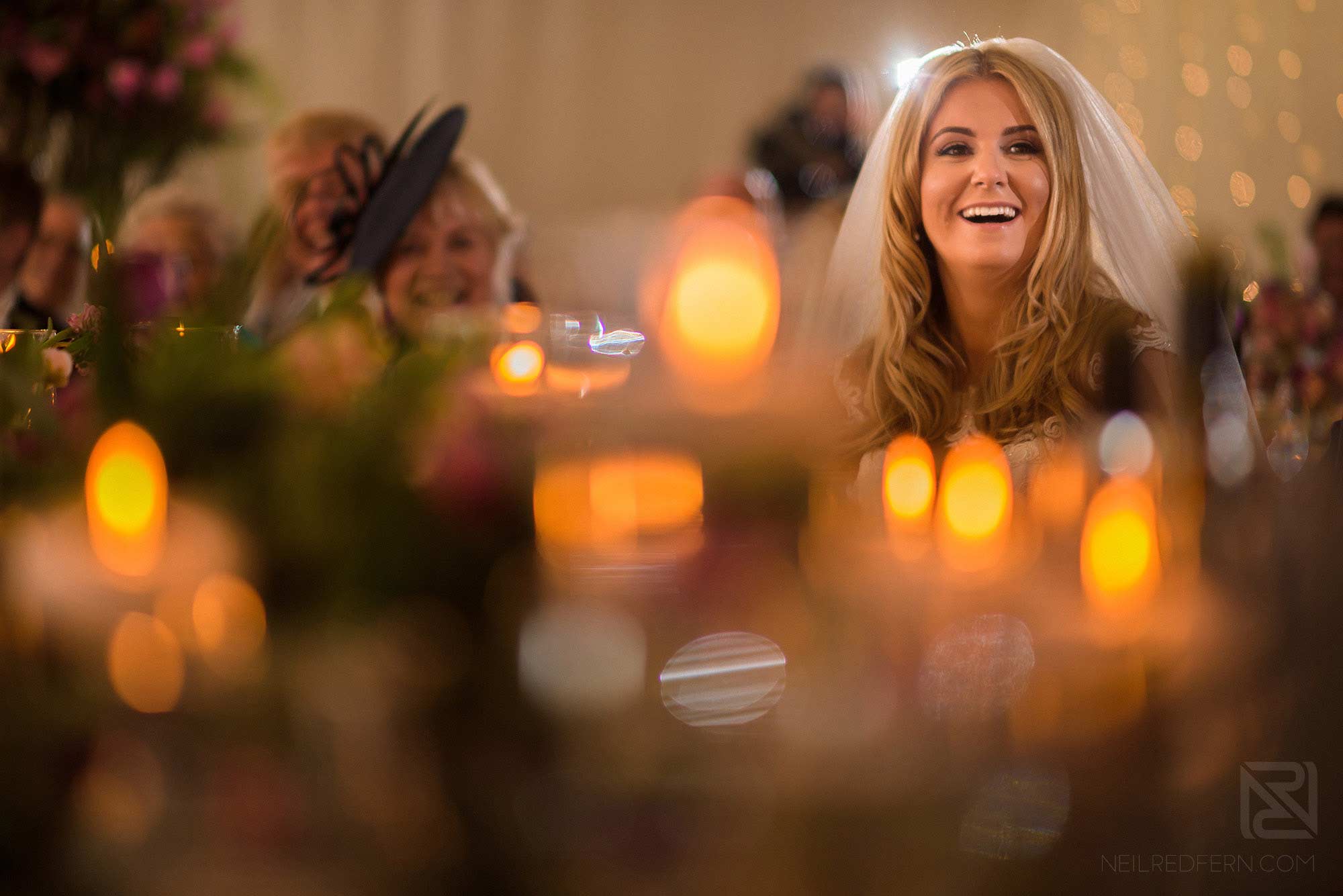 bride laughing during wedding speech