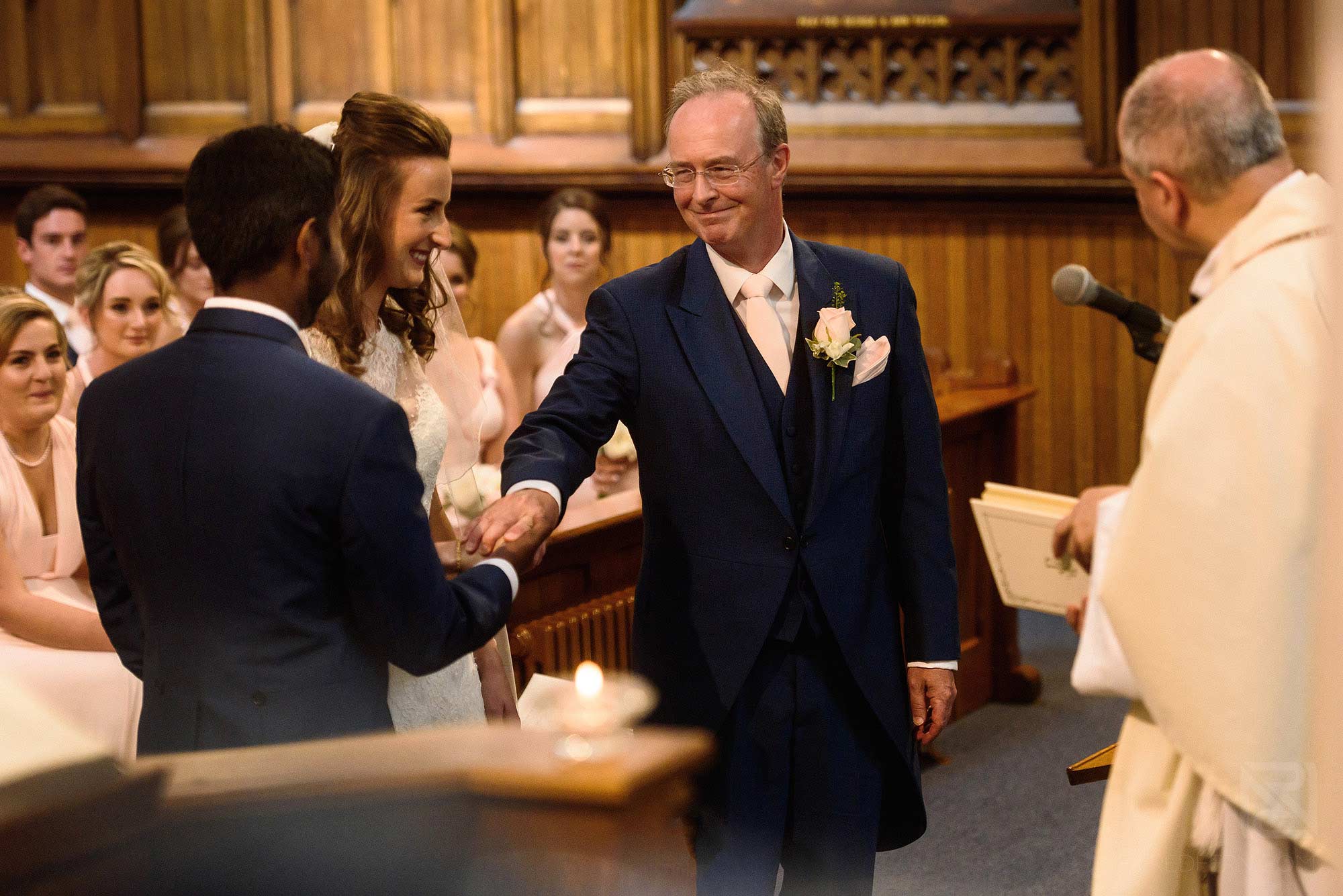 father of bride giving away daughter to groom