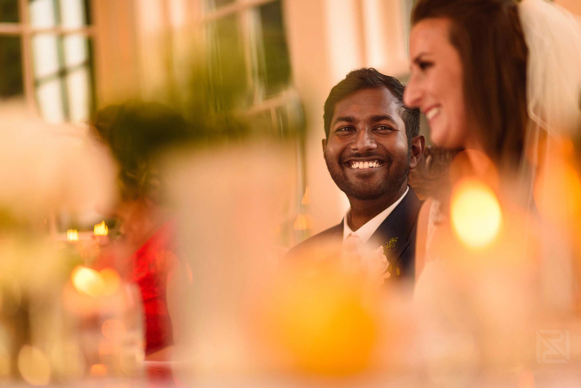 groom laughing during best man's speech