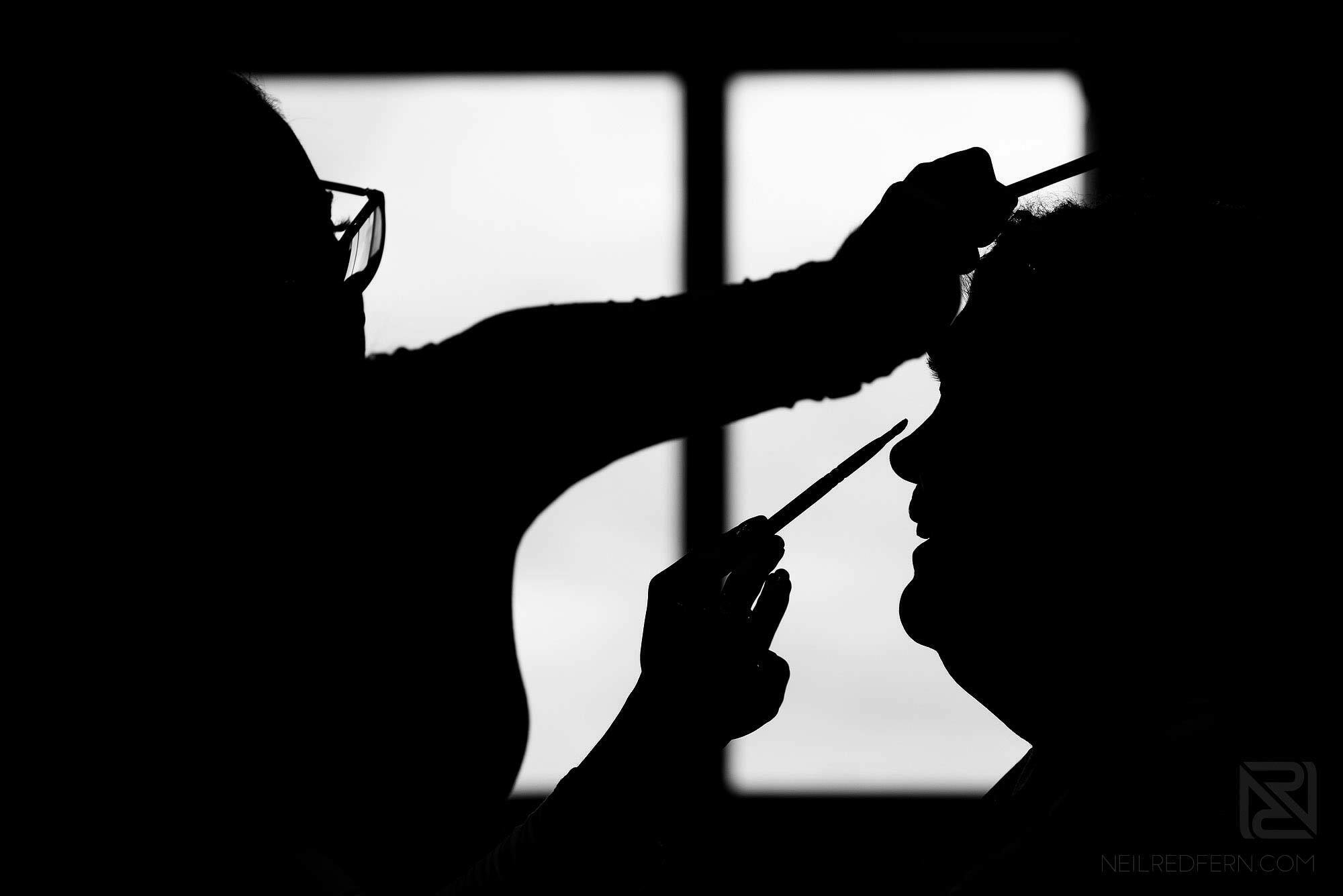 silhouette photograph of make up being put on