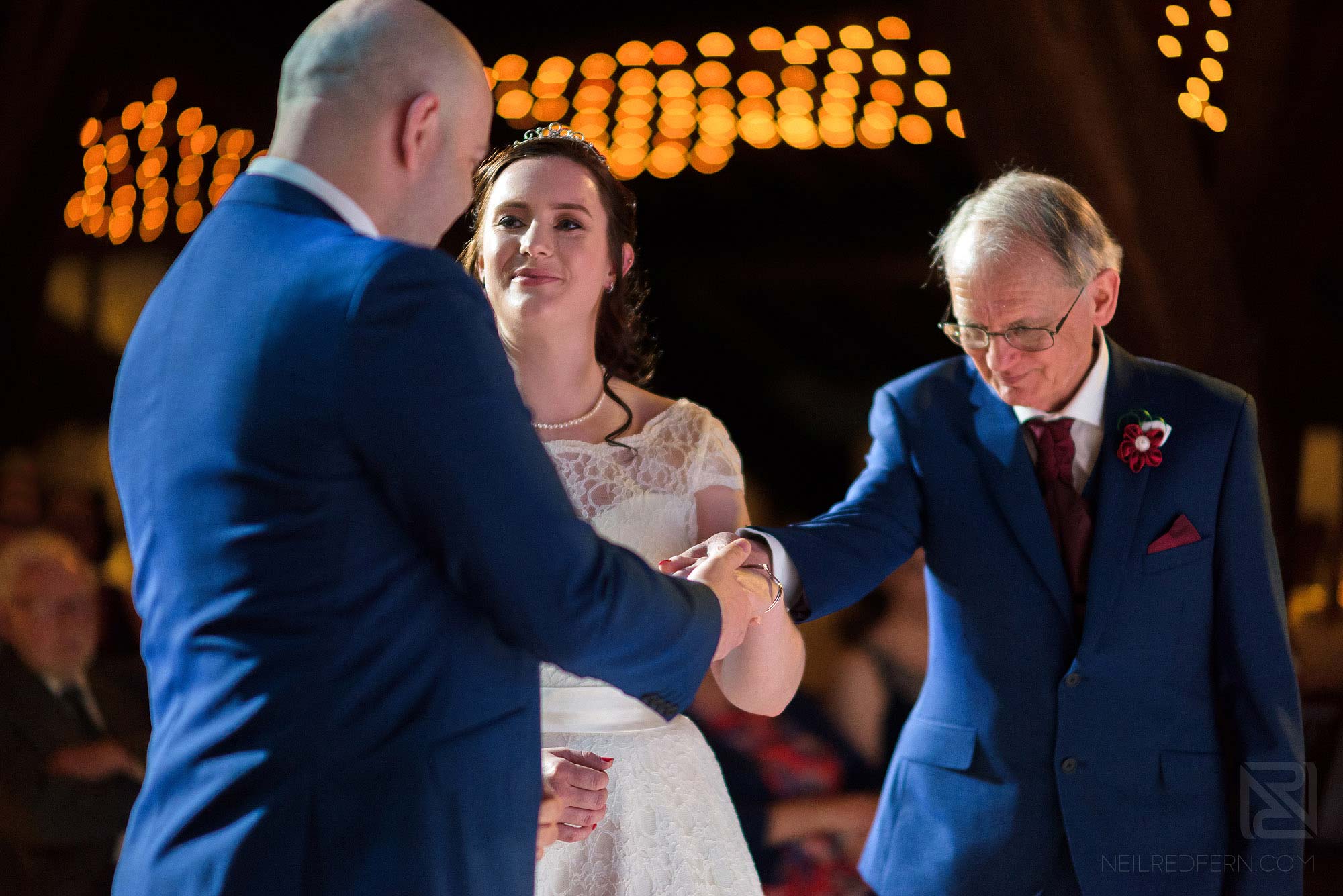 father handing over daughter during wedding ceremony
