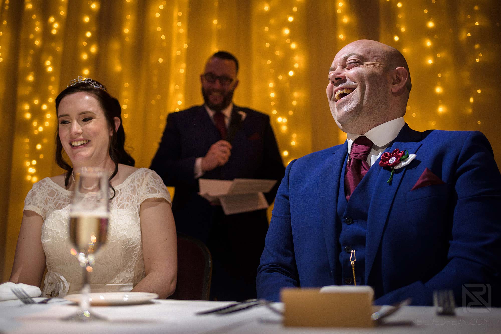 groom laughing during Best Man's wedding speech