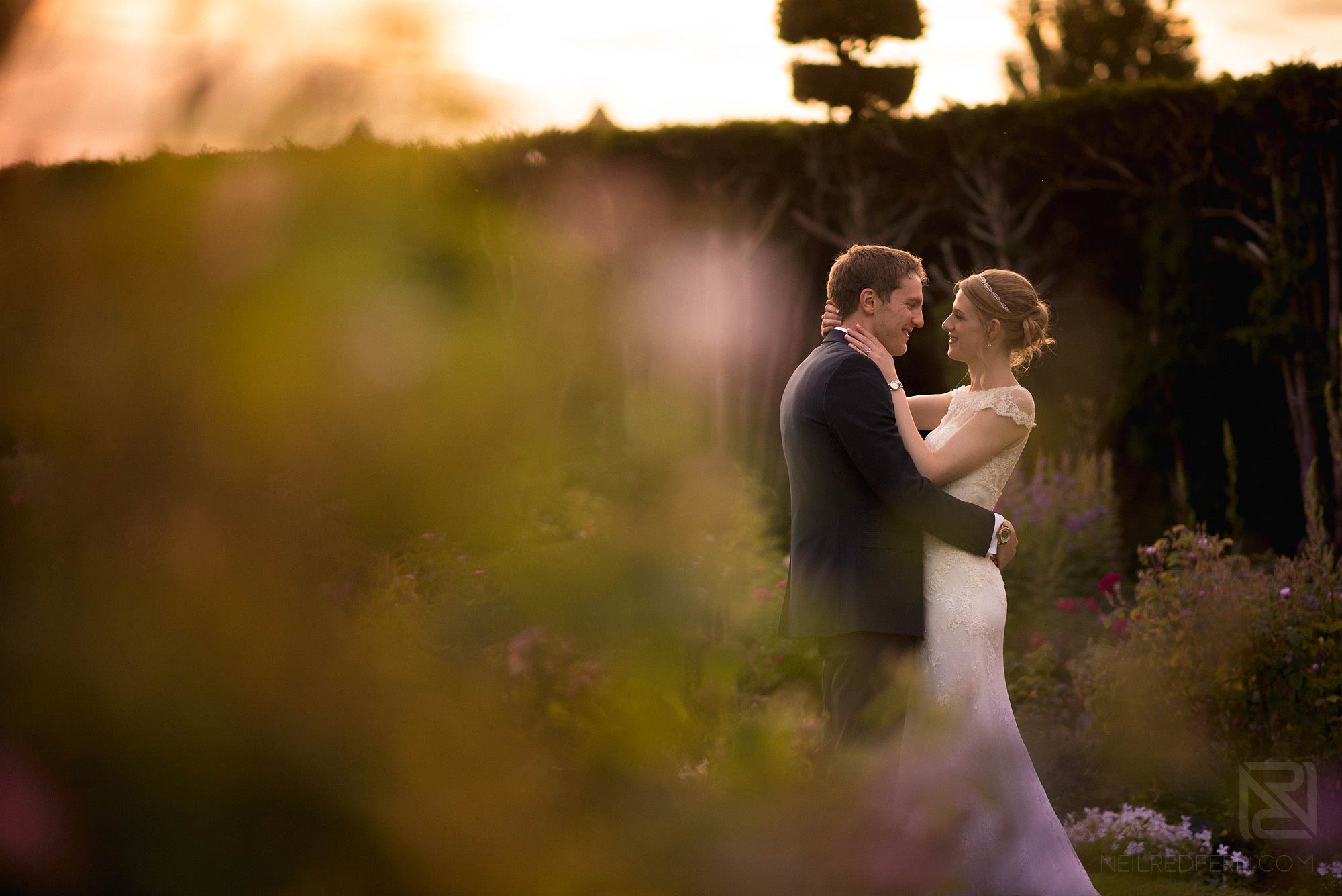 portrait of bride and groom in the gardens at Arley Hall