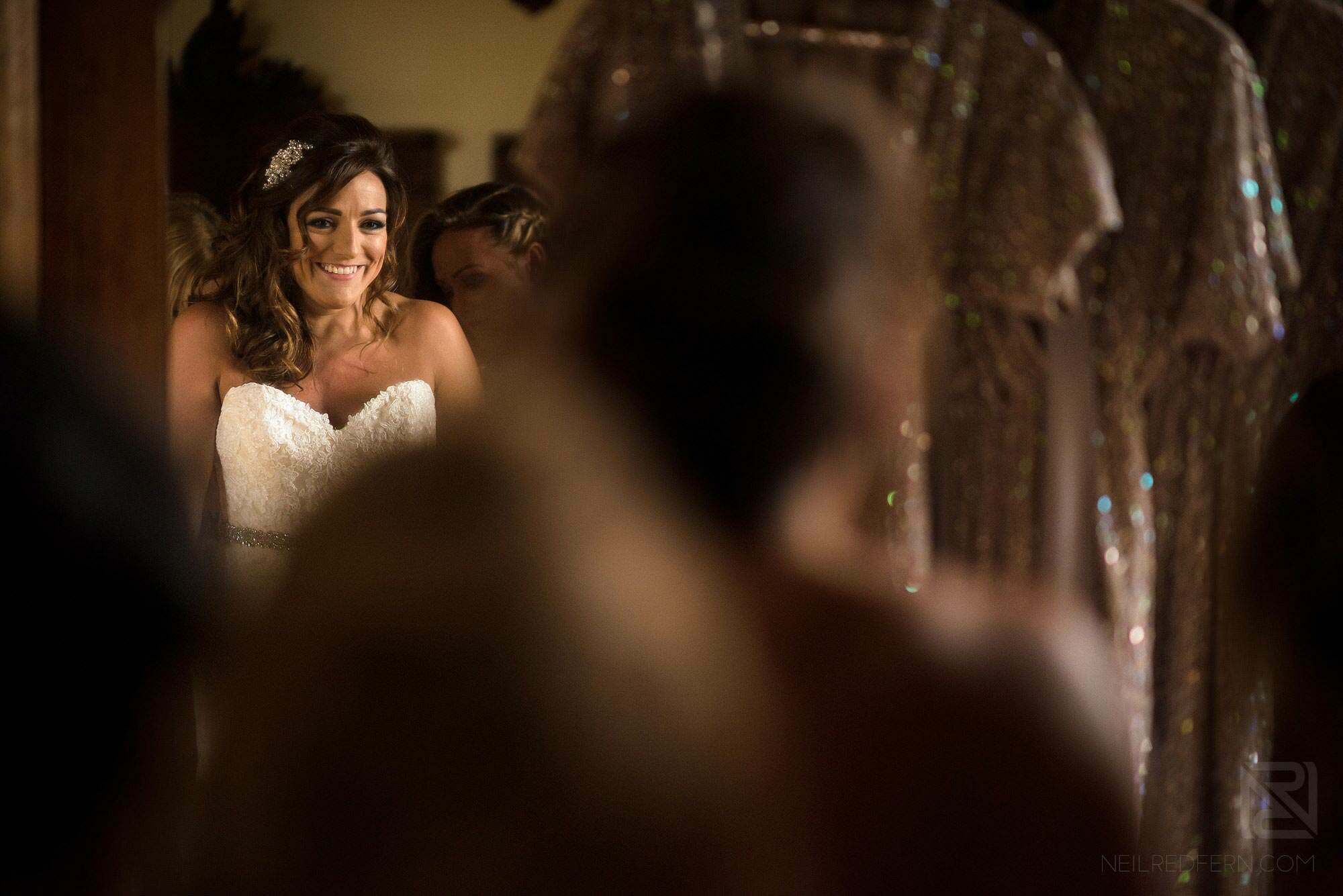 bride looking excited in mirror