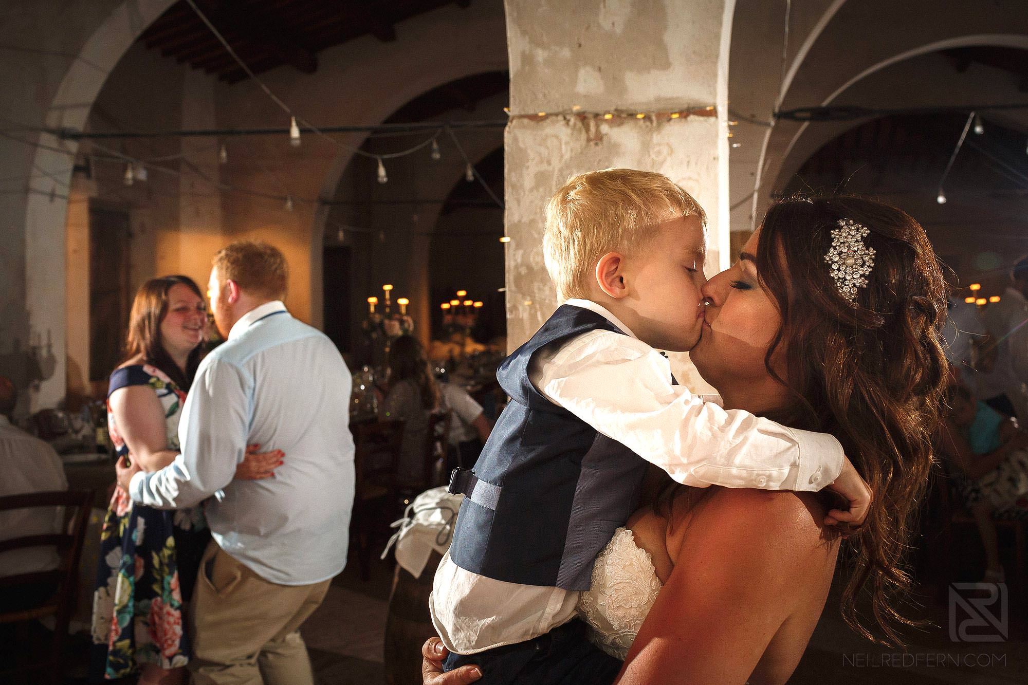 bride kissing son on dancefloor