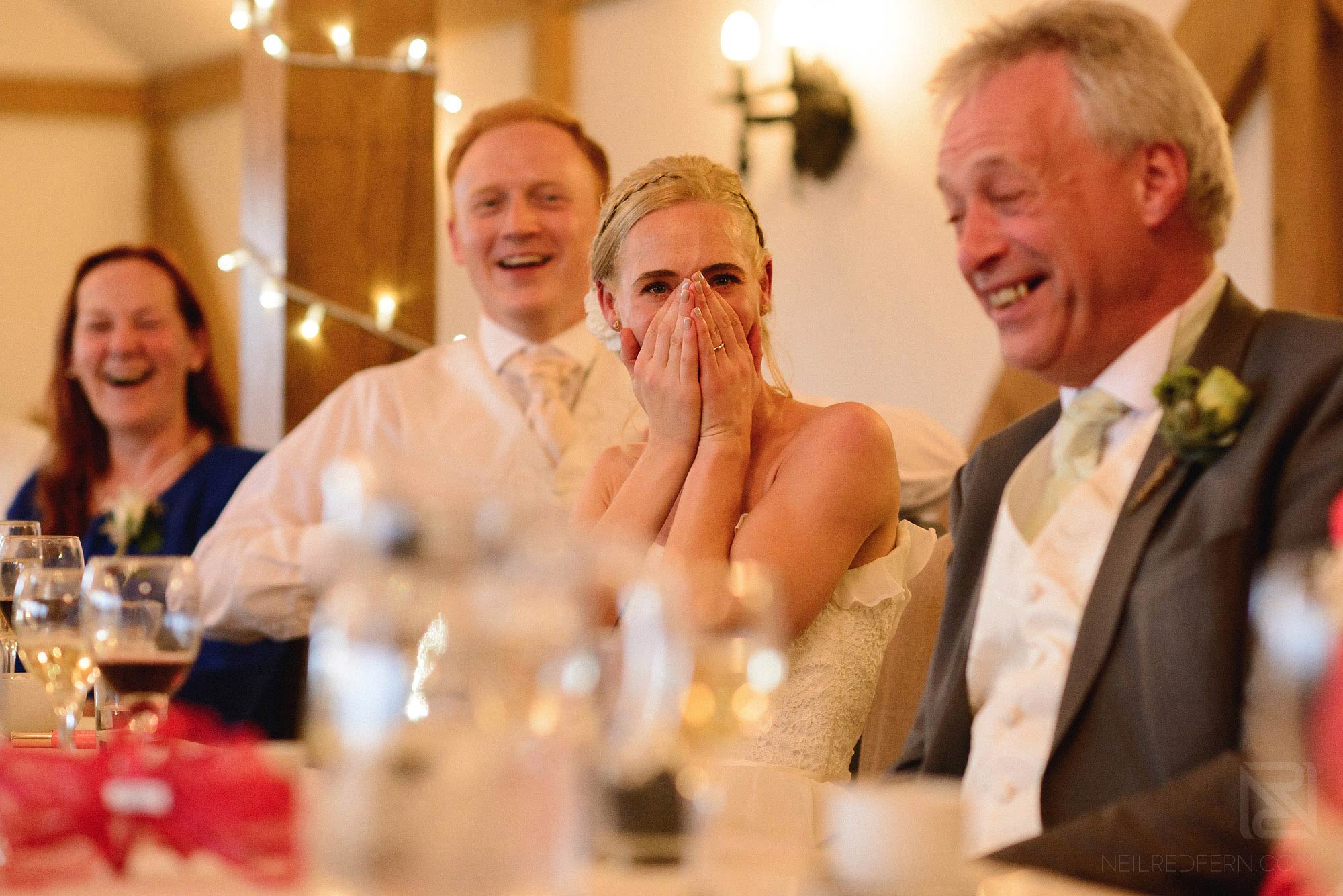 top table laughing during wedding speeches