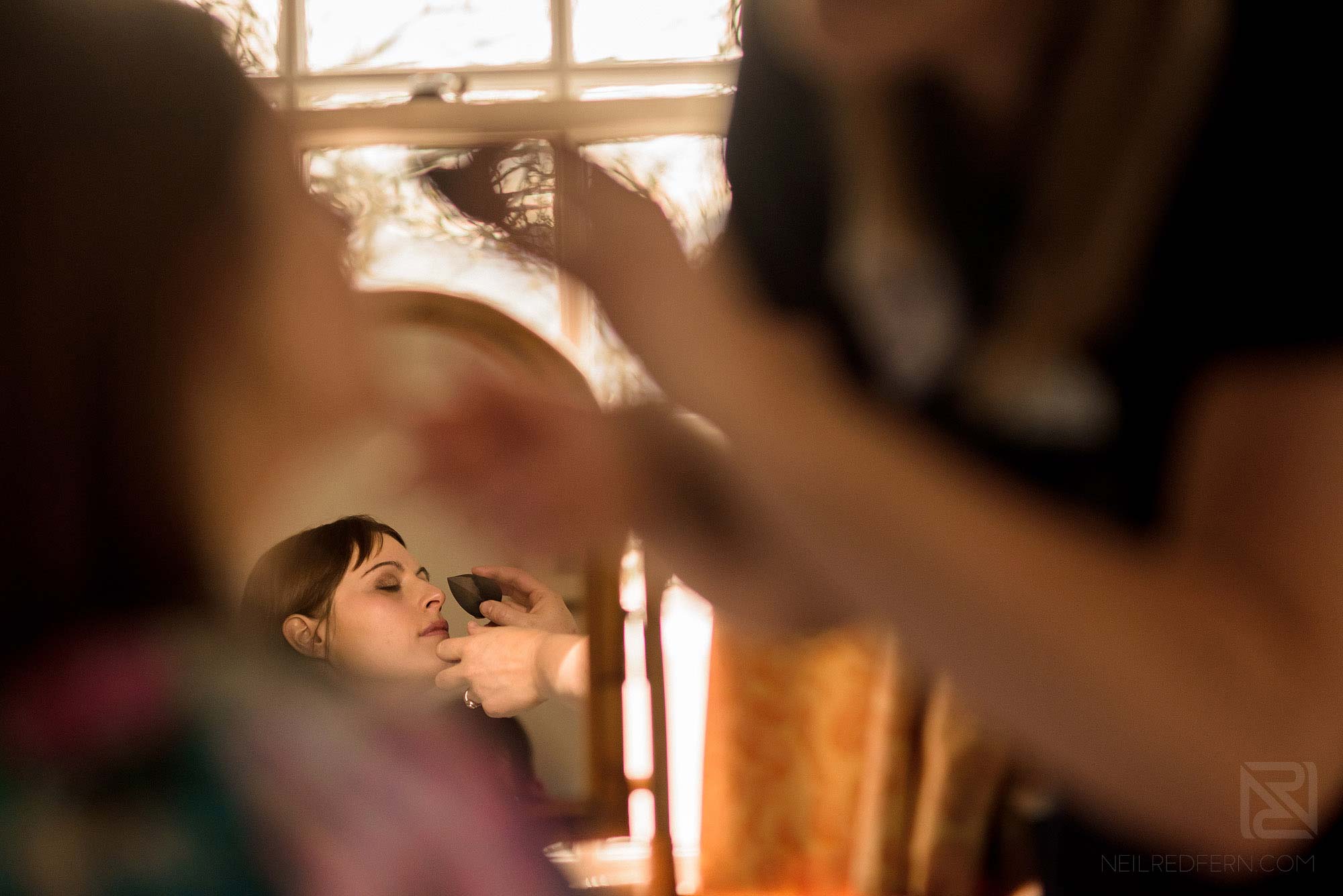bridesmaid having make-up applied on morning of wedding