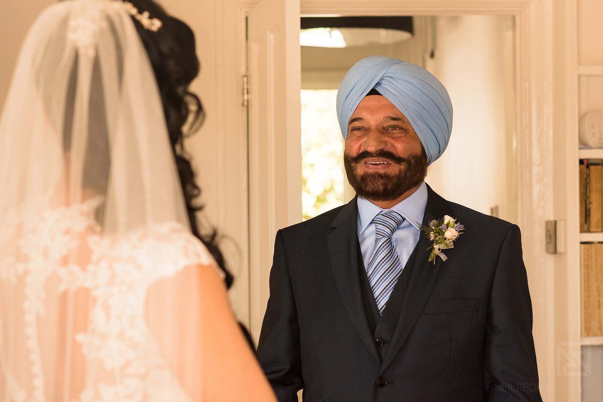 father of bride seeing daughter in wedding dress for first time