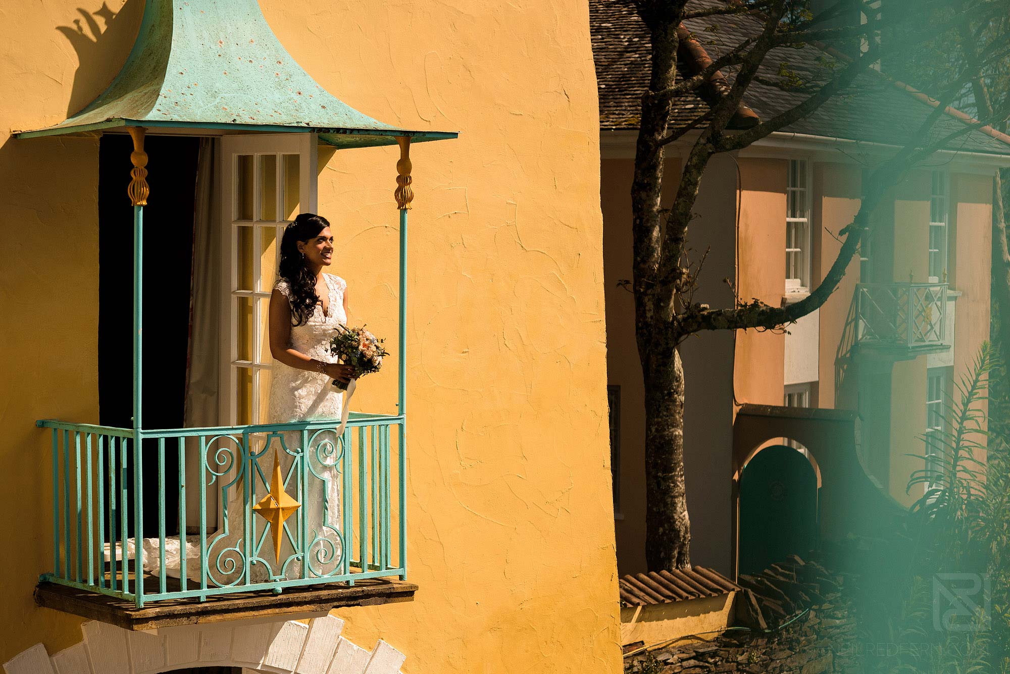 bride stood on balcony in Portmeirion