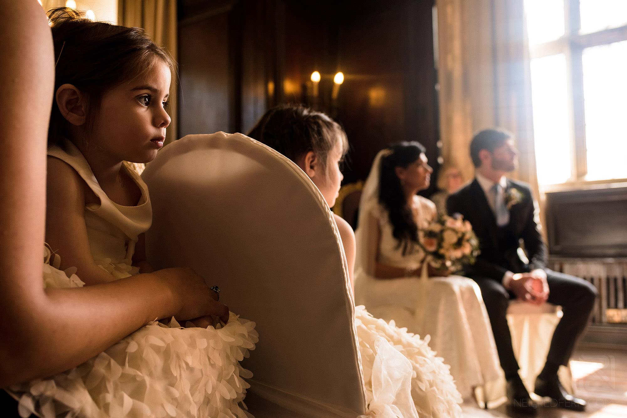 flower girl sat quietly during wedding ceremony