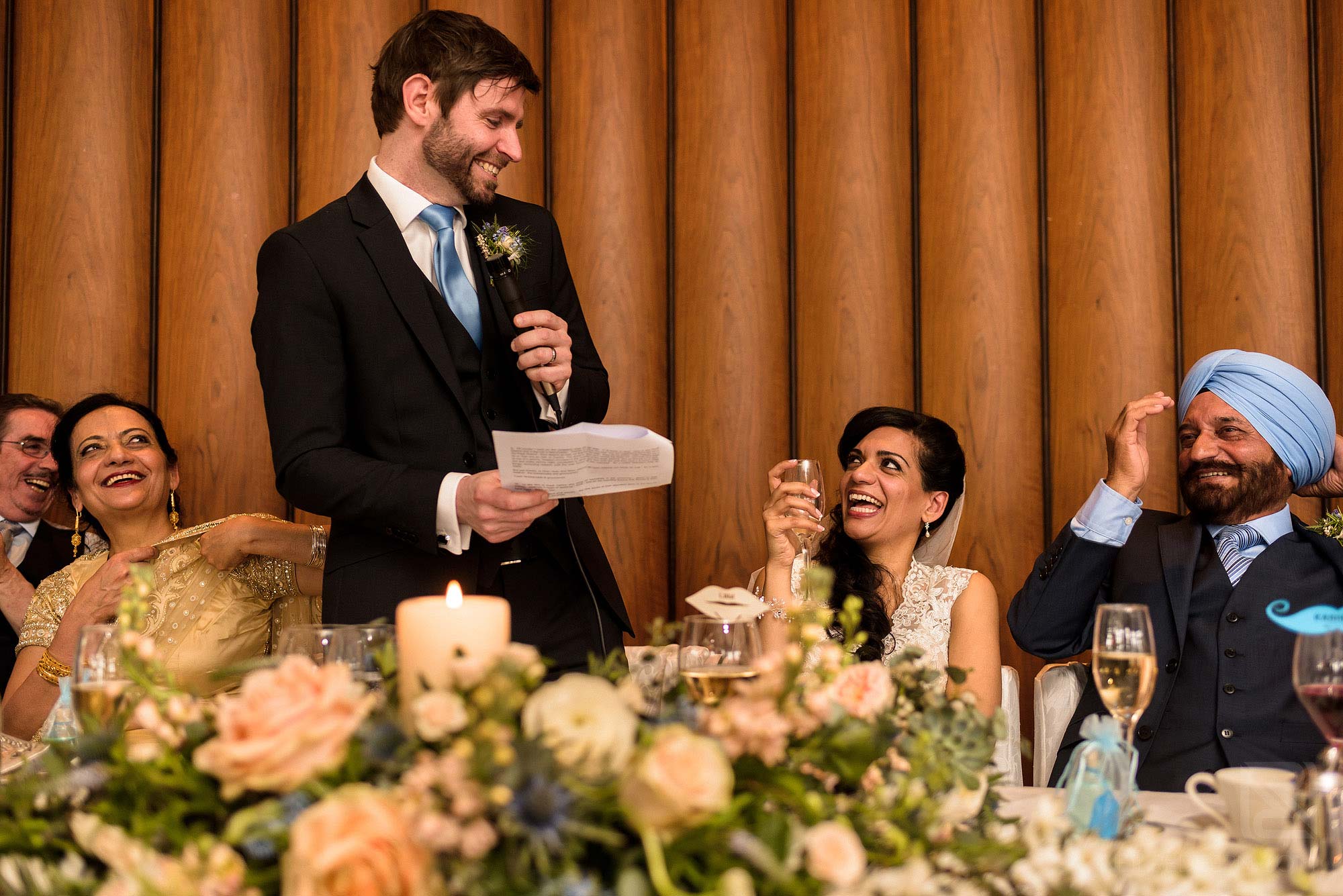 top table laughing during groom's wedding speech