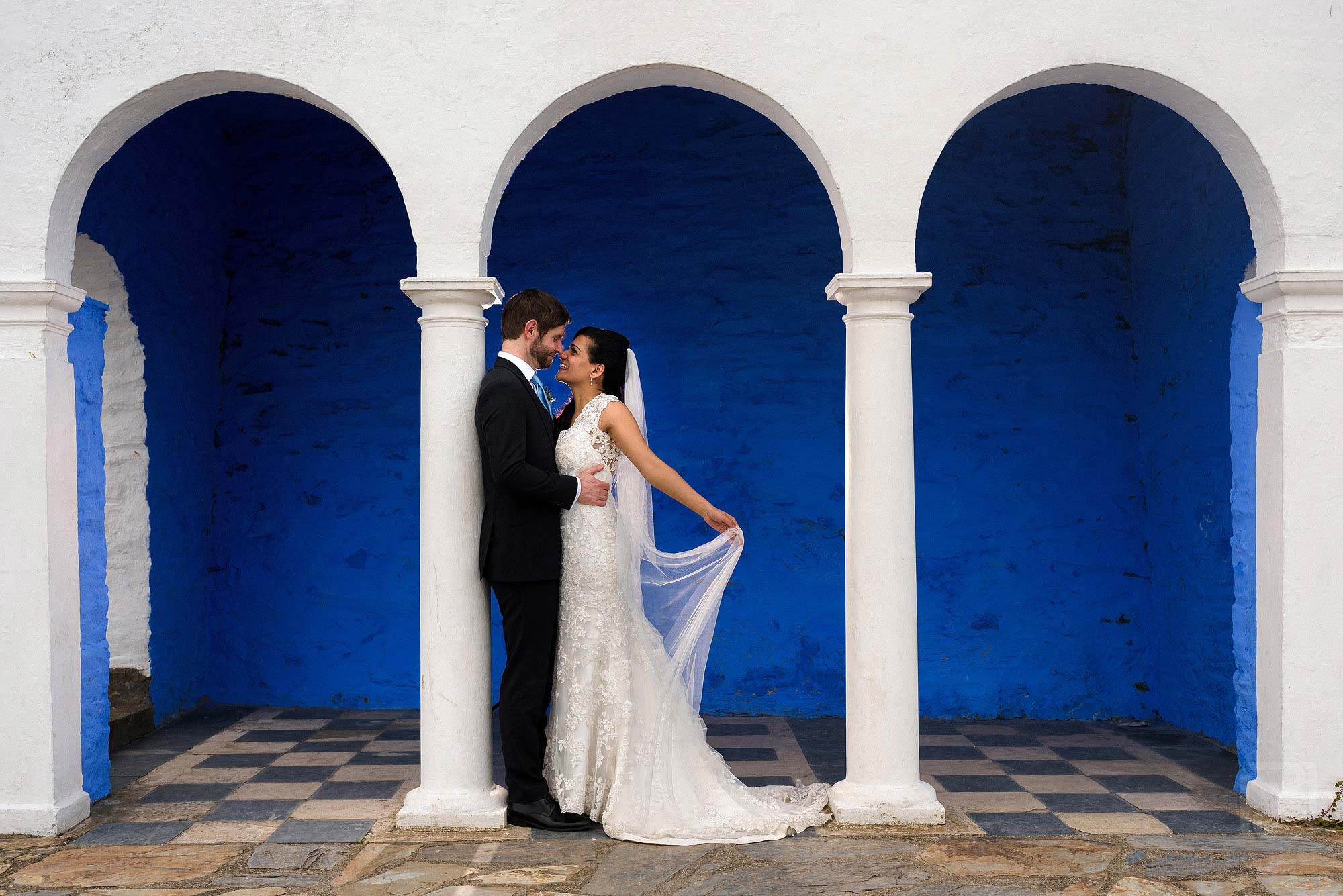 beautiful photograph of bride and groom under arches at Portmeirion