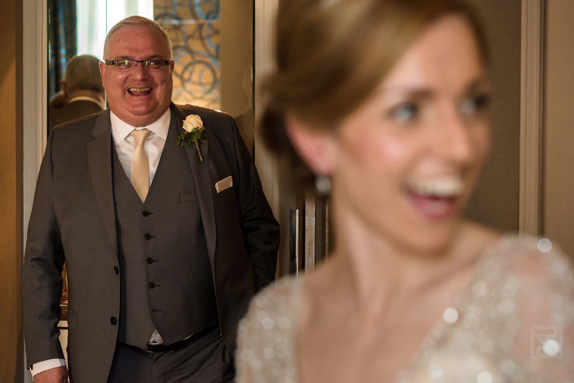 father and bride laughing together