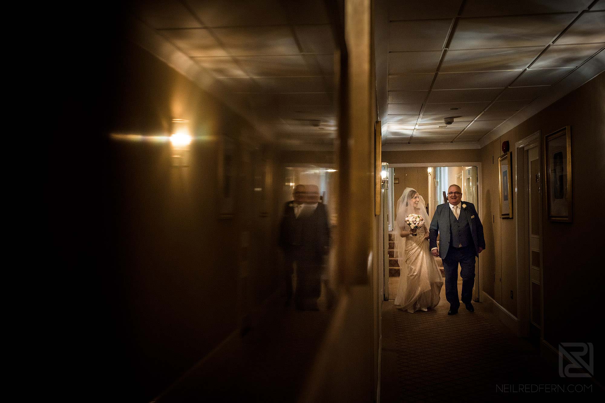 bride and dad walking through Chester Grosvenor on wedding day