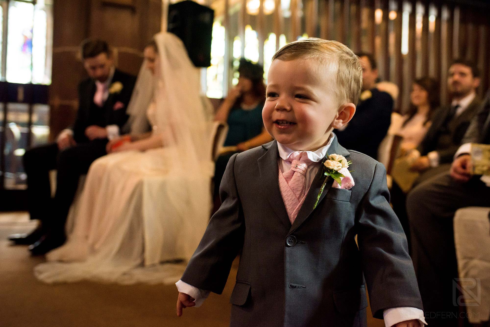 page boy smiling in church