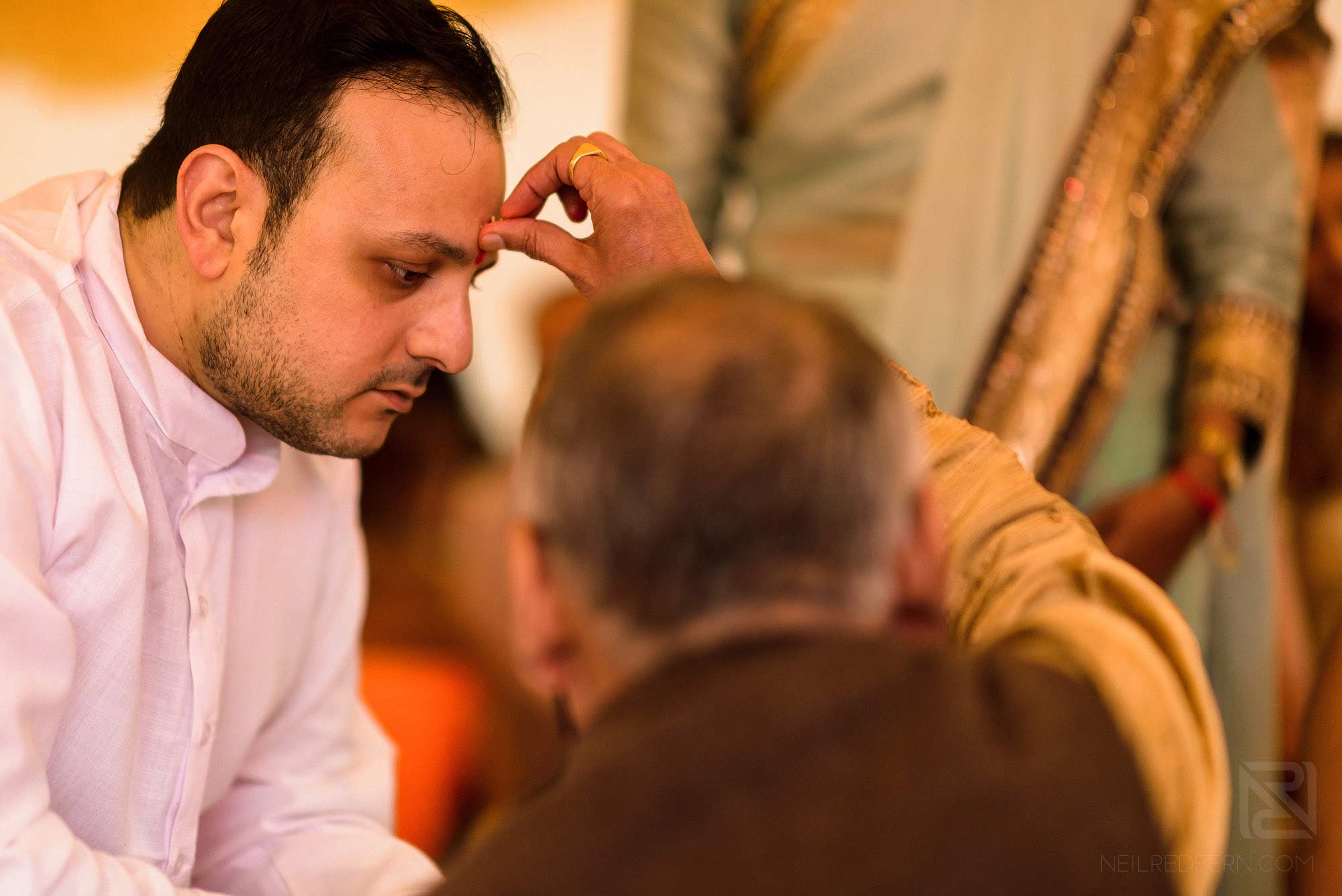 priest and groom during Haldi ceremony