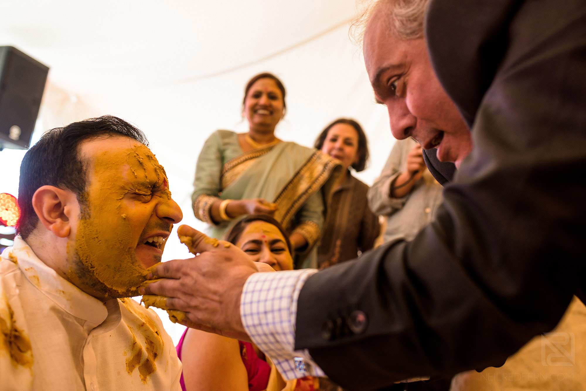 groom laughing during Haldi ceremony