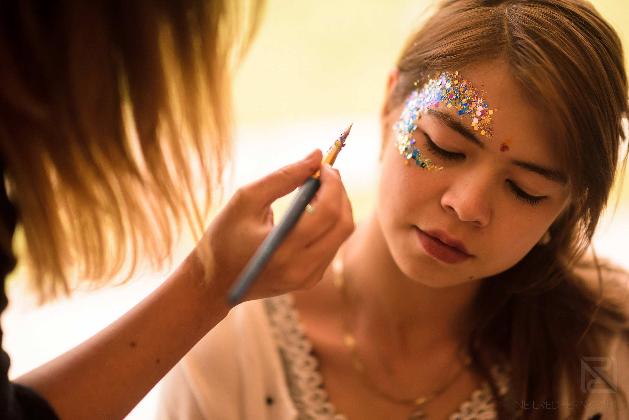 make-up artist putting on glitter