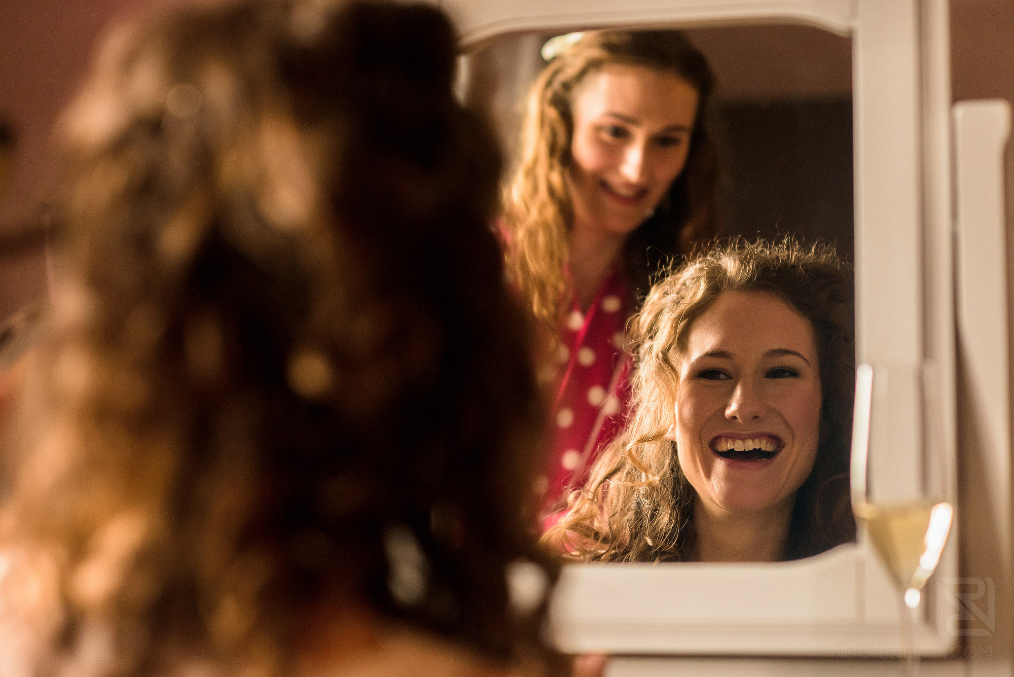bride laughing looking in mirror