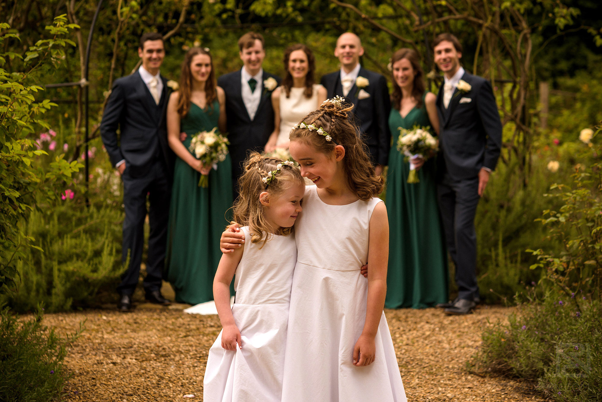 flowergirls hugging each other during group shots