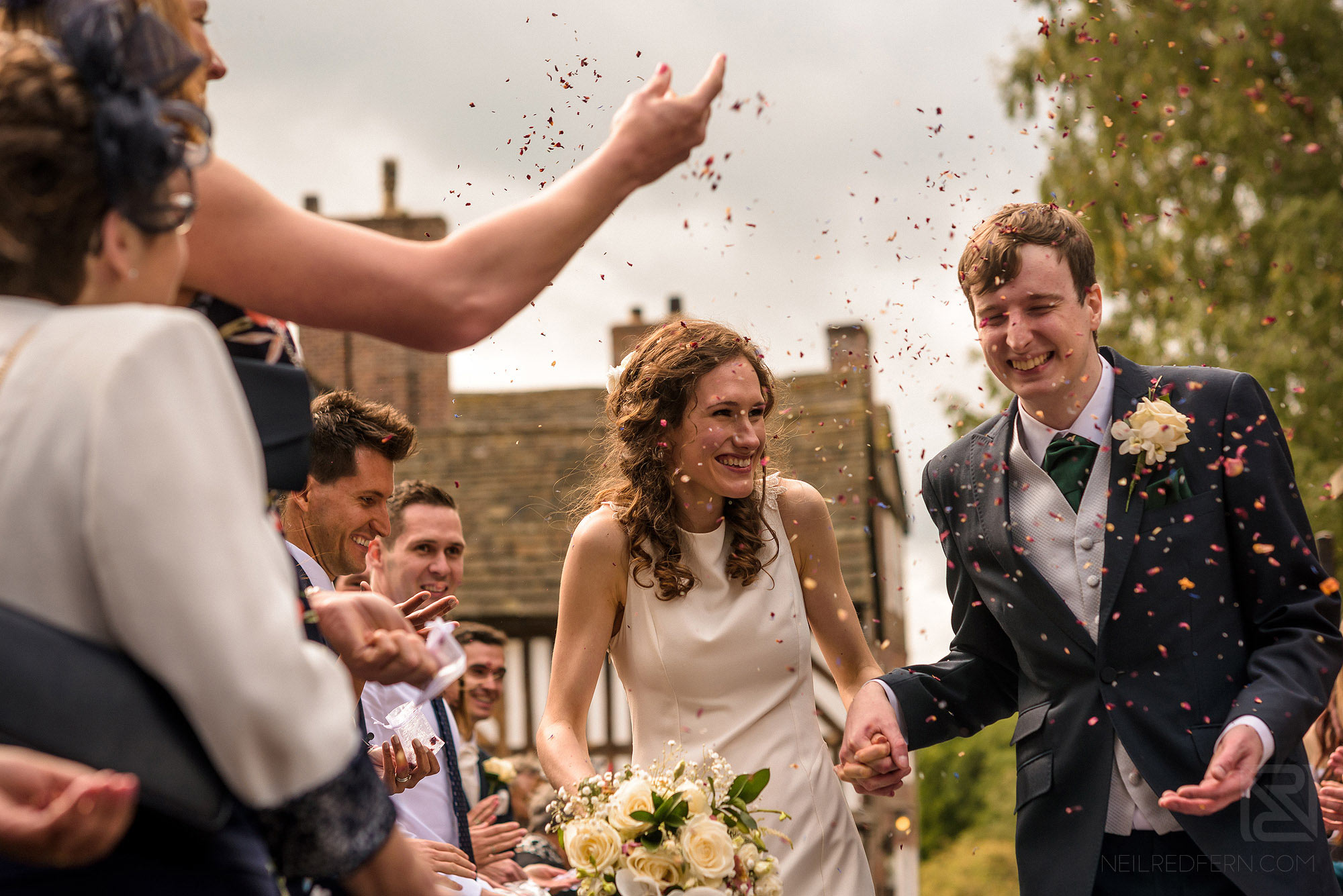 wedding guests throwing confetti