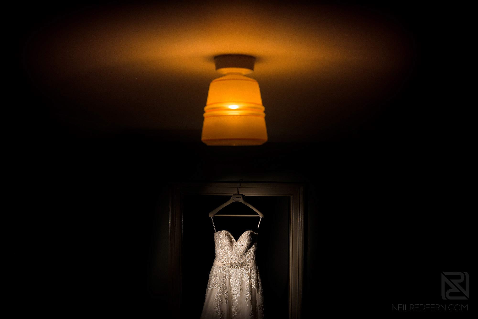 Summer wedding at Arley Hall 1 wedding dress hung up inside Arley Hall