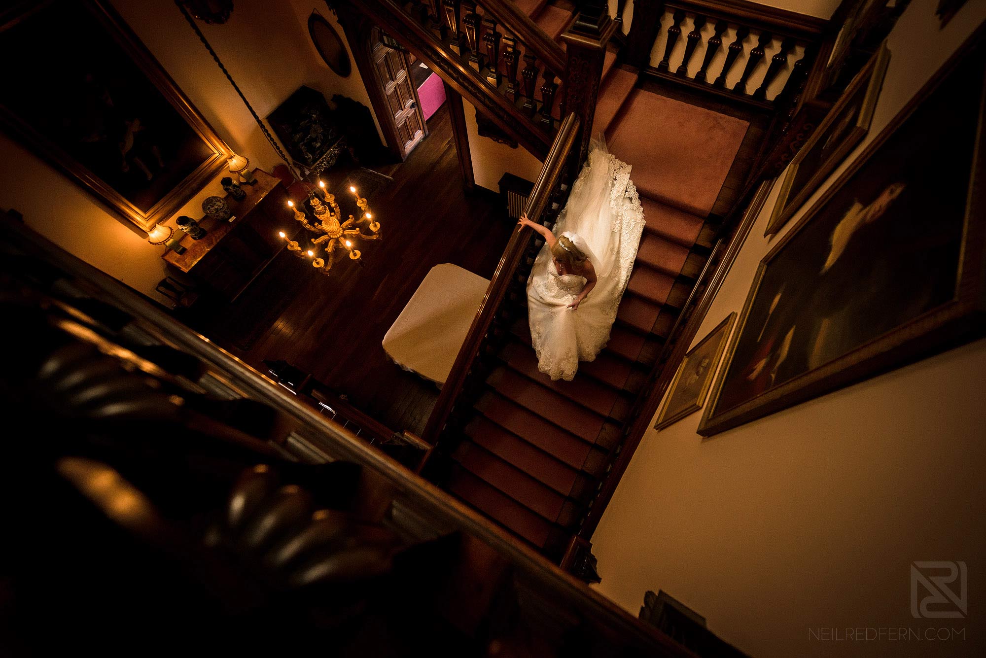 Summer wedding at Arley Hall 9 bride walking down stairs in Arley Hall