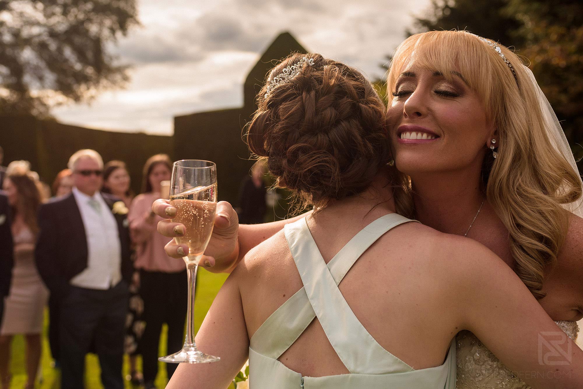 Summer wedding at Arley Hall 18 bridesmaid hugging bride