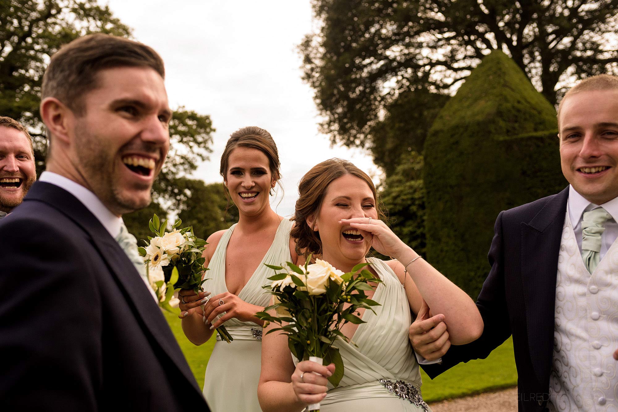 Summer wedding at Arley Hall 23 bridal party laughing