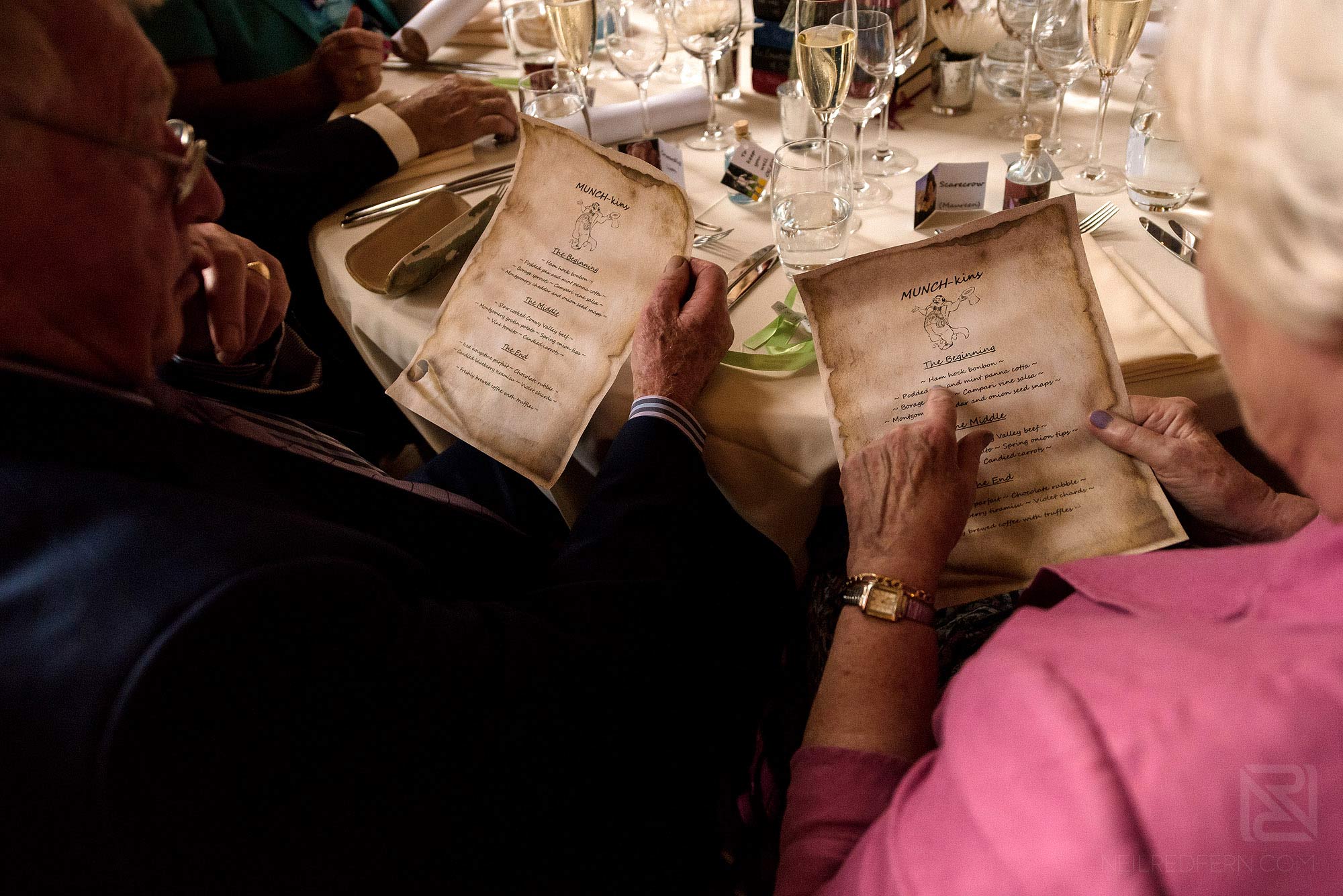 Summer wedding at Arley Hall 30 wedding guests reading wedding breakfast menu