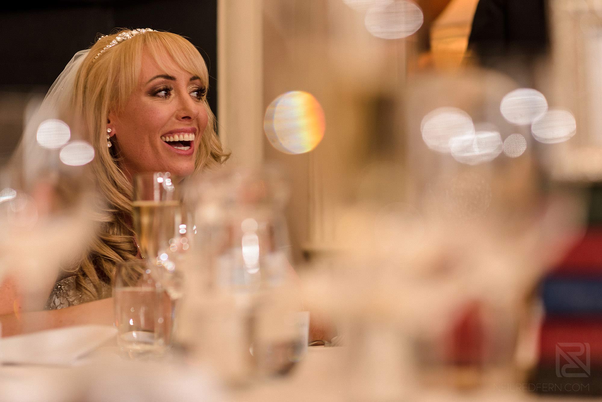 Summer wedding at Arley Hall 33 bride smiling during wedding speeches at Arley Hall summer wedding
